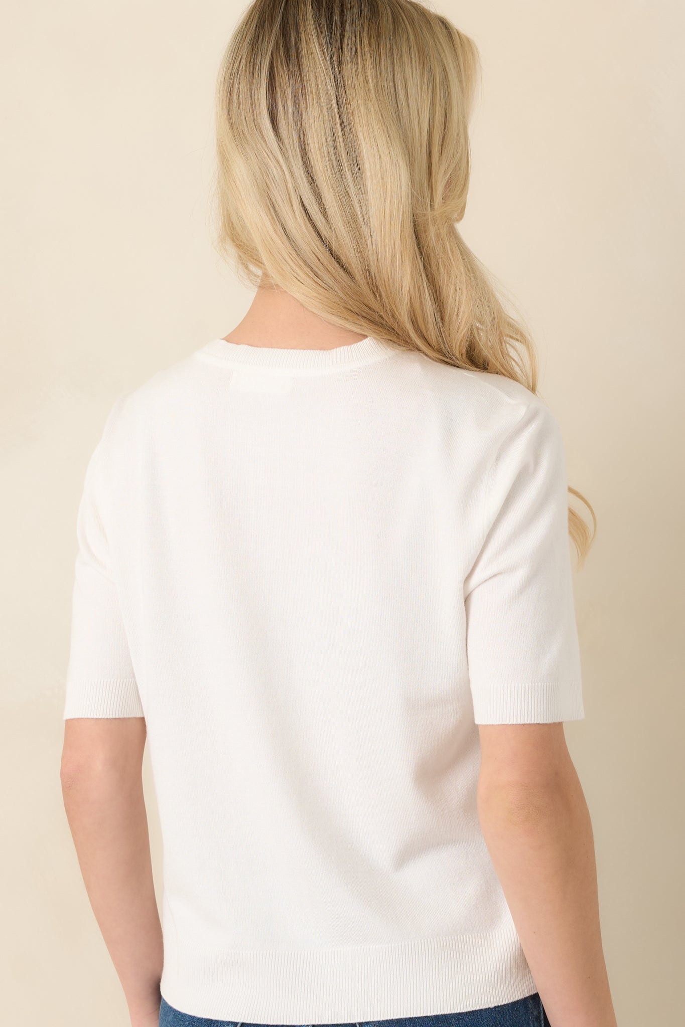 Soft knit top with short sleeves and smooth silhouette.