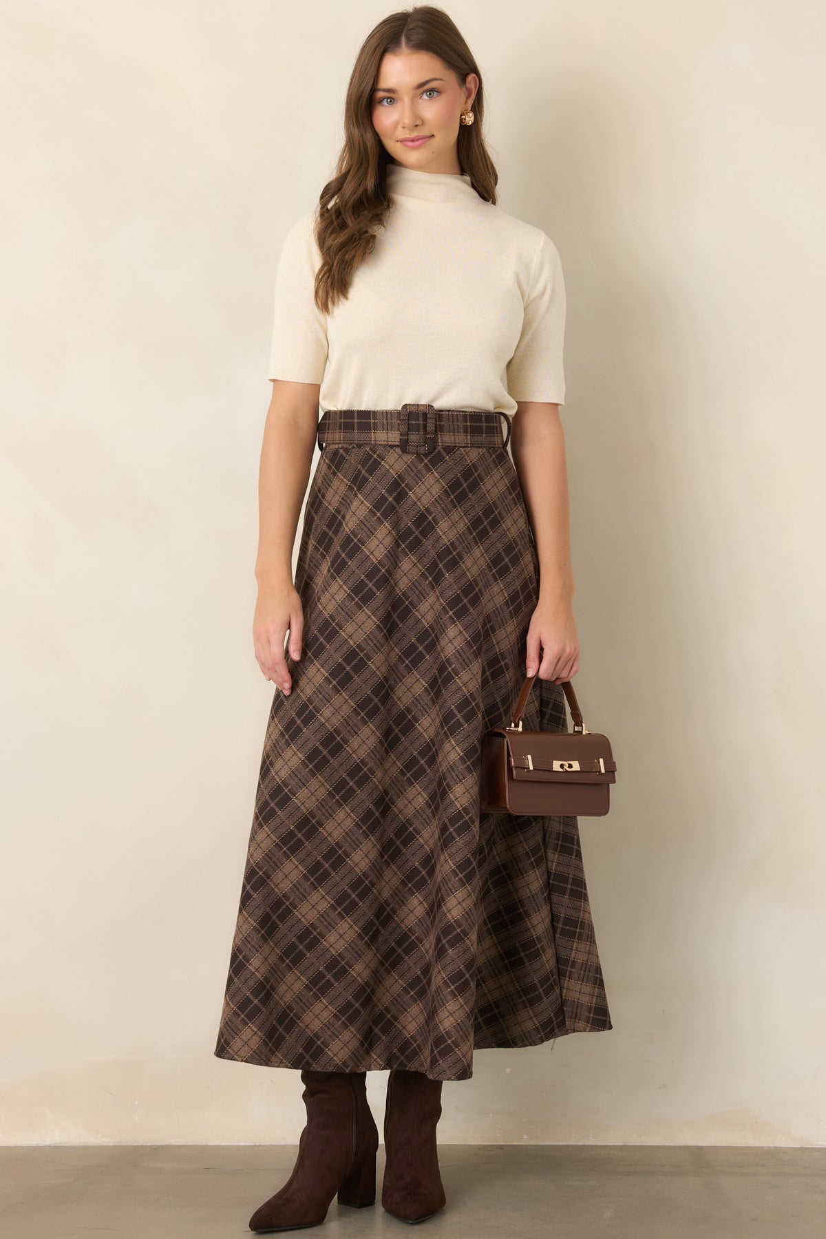 Soft knit top featuring a high turtleneck neckline, short sleeves, and a clean, streamlined silhouette.
