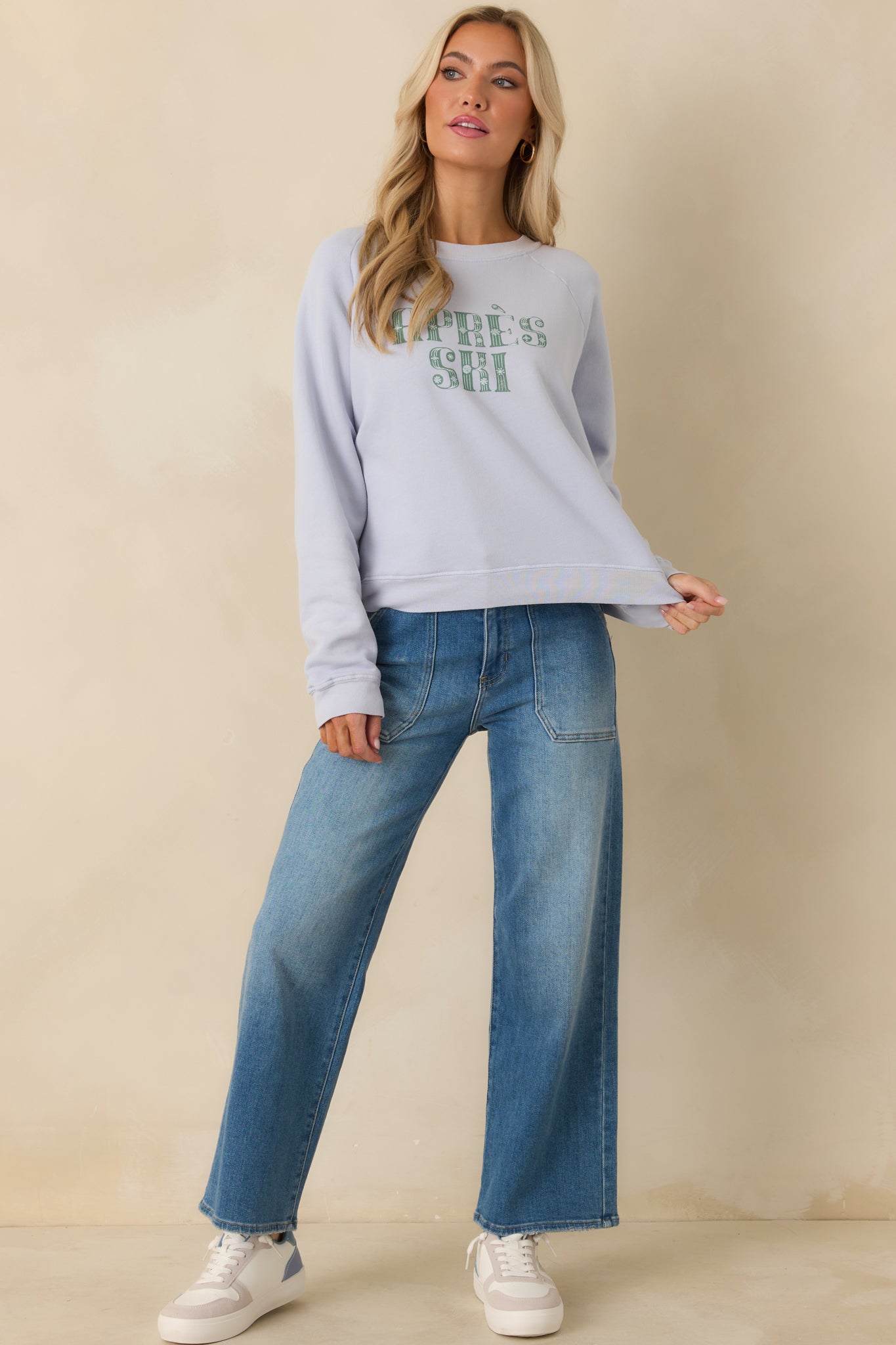 Soft light blue sweatshirt featuring a classic crew neckline, long raglan sleeves, and casual fit.