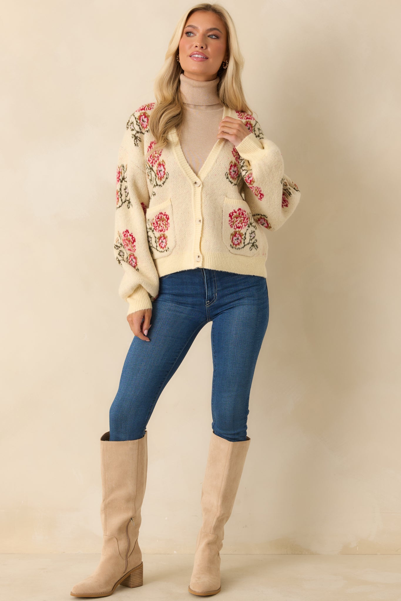 Soft mid-weight cardigan featuring button-front styling, long sleeves, and subtle floral details for a timeless look.