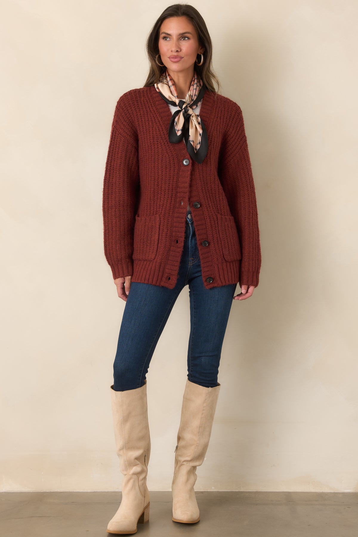Soft mixed-fiber knit cardigan with long sleeves, a dark button front, and wide ribbed edging throughout.