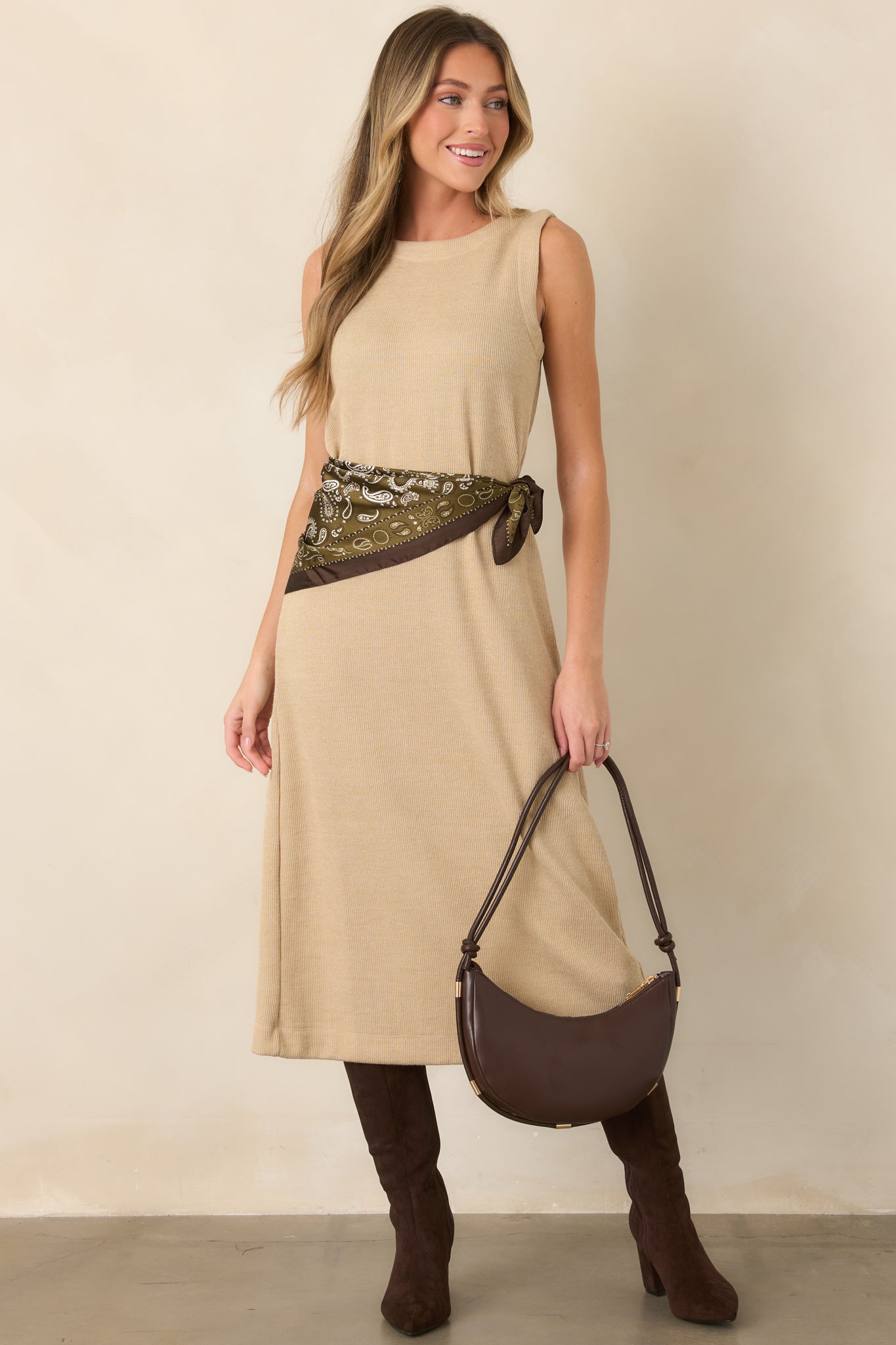 Soft natural midi dress showcasing its sleeveless design, gently rounded neckline, and comfortable ribbed knit construction.