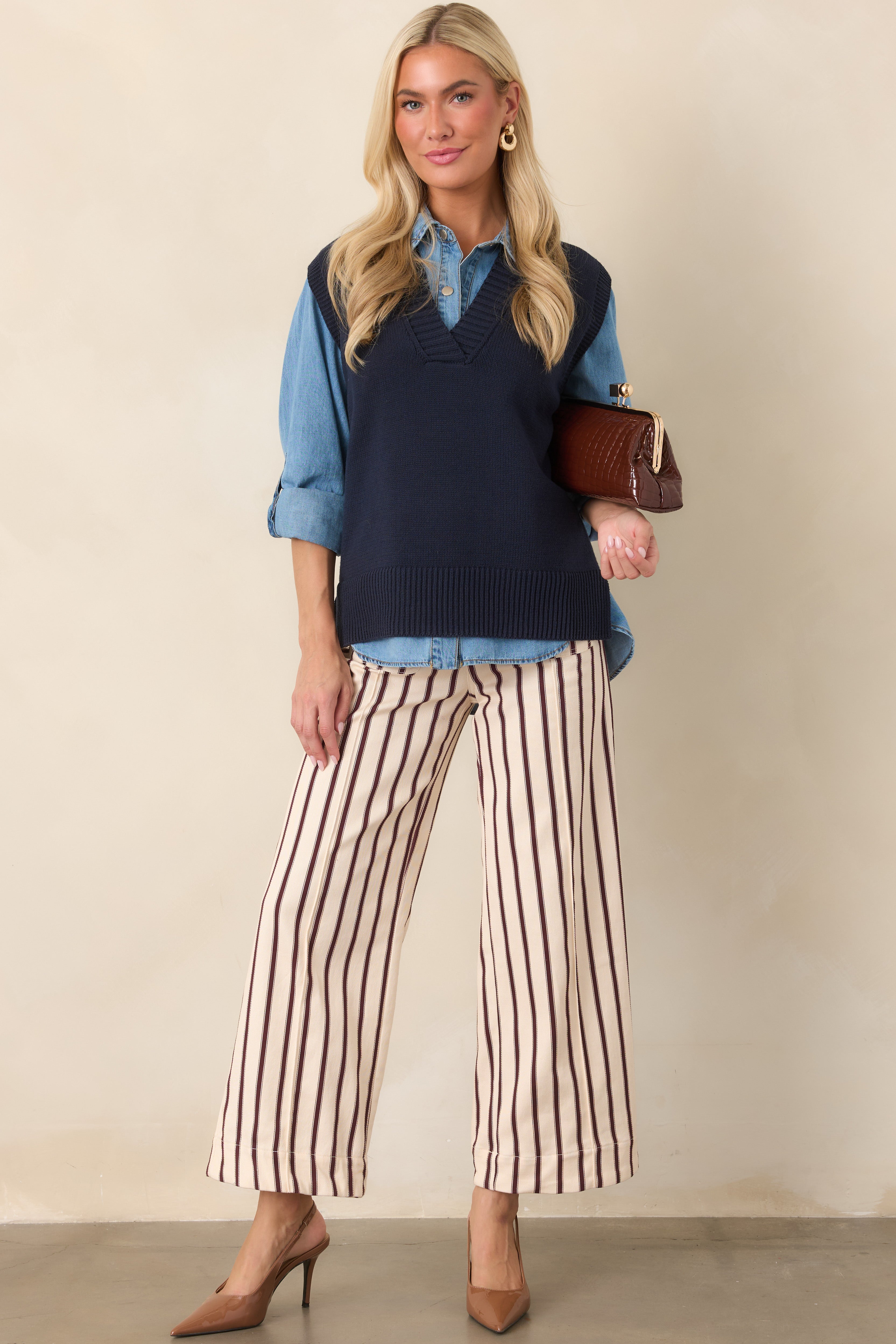 Soft navy sweater vest featuring a clean V-neck, ribbed arm openings, and a wide ribbed hem for a polished finish.