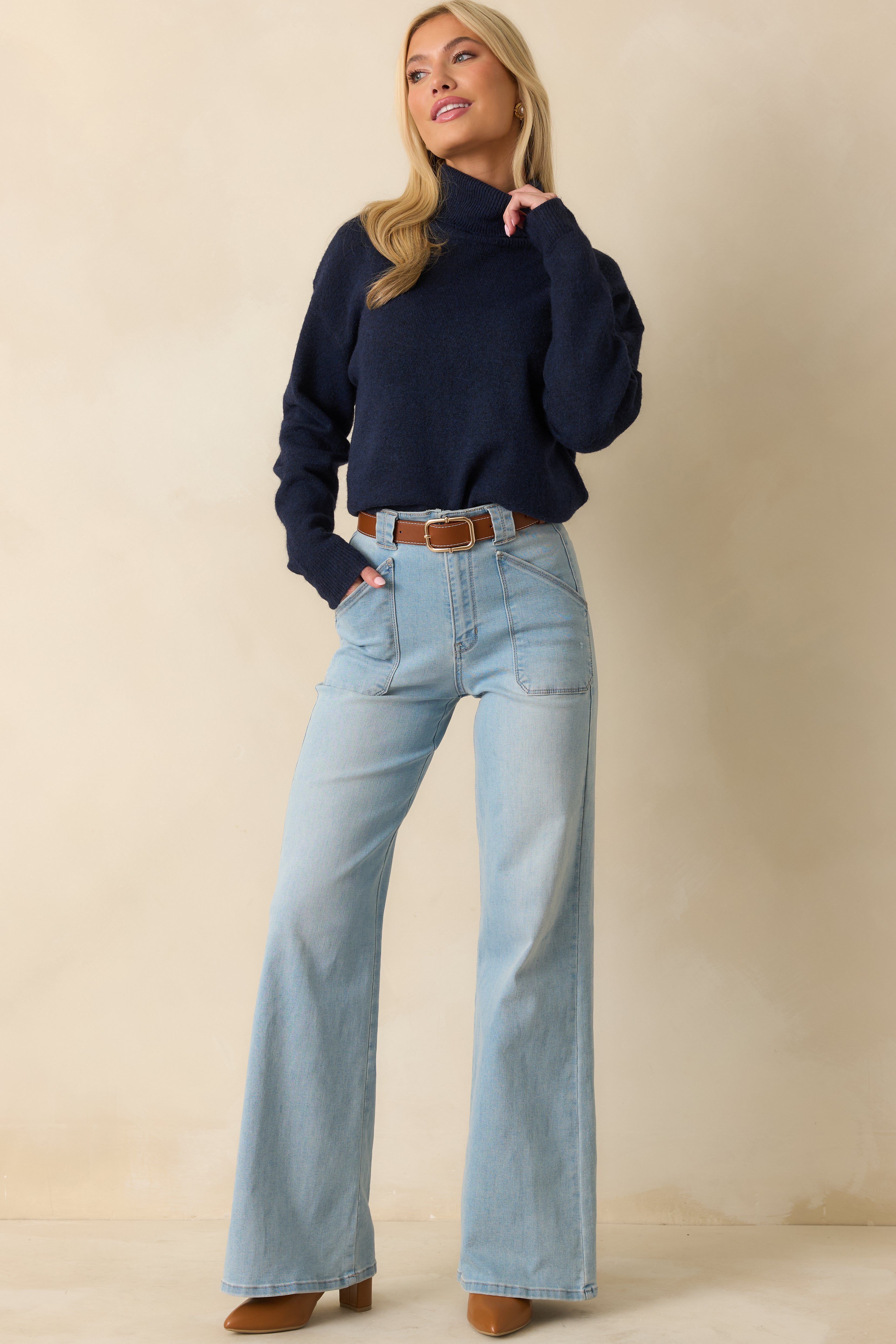 Soft navy sweater with long sleeves, ribbed edges, and casual, loose fit.