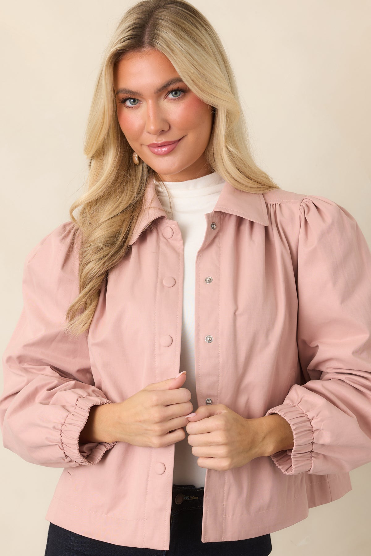 Soft pink jacket emphasizing the elasticized cuffs and relaxed cropped hem.