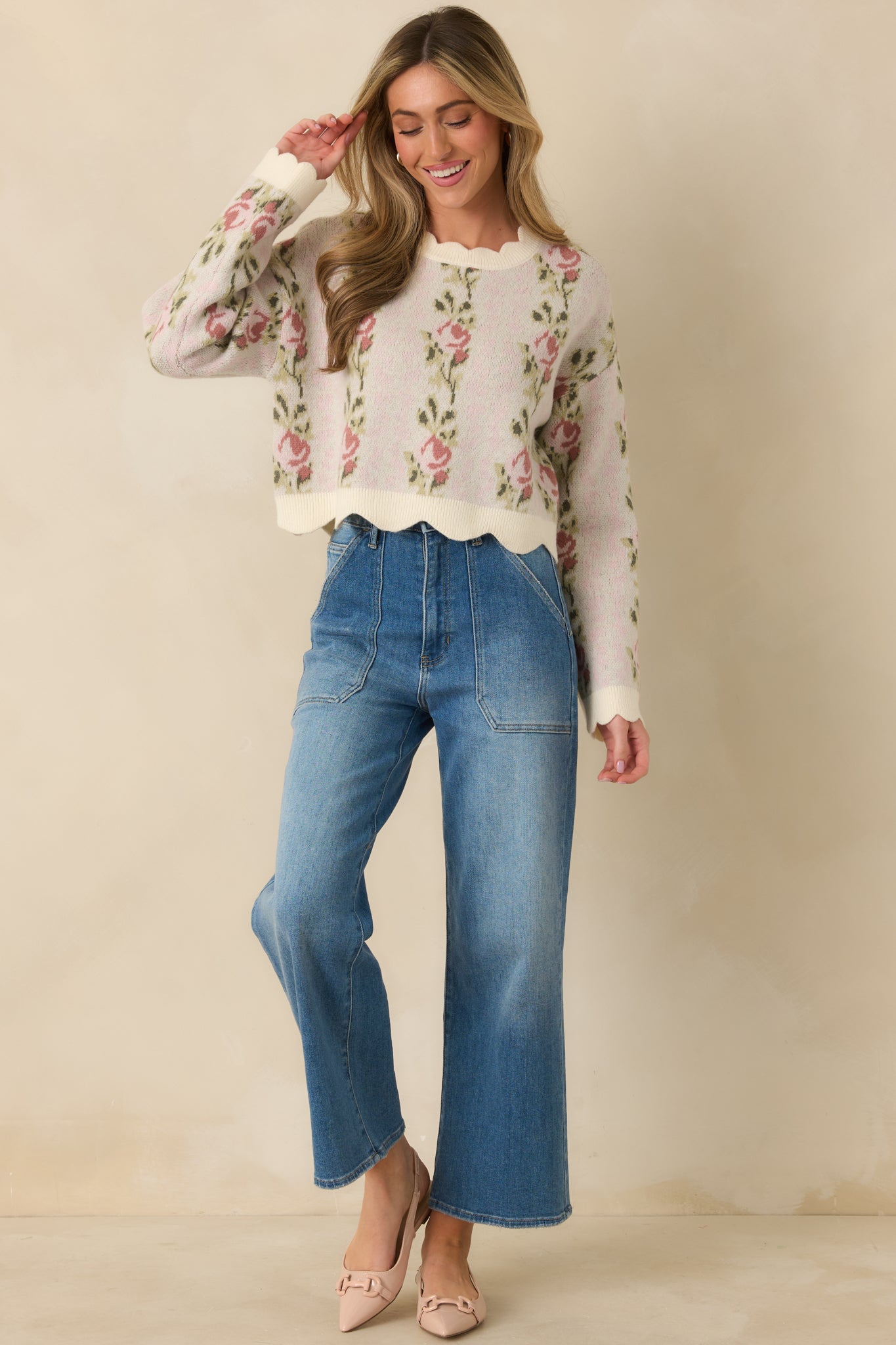 Soft pink sweater featuring an allover floral knit pattern, relaxed fit, and subtly cropped length.