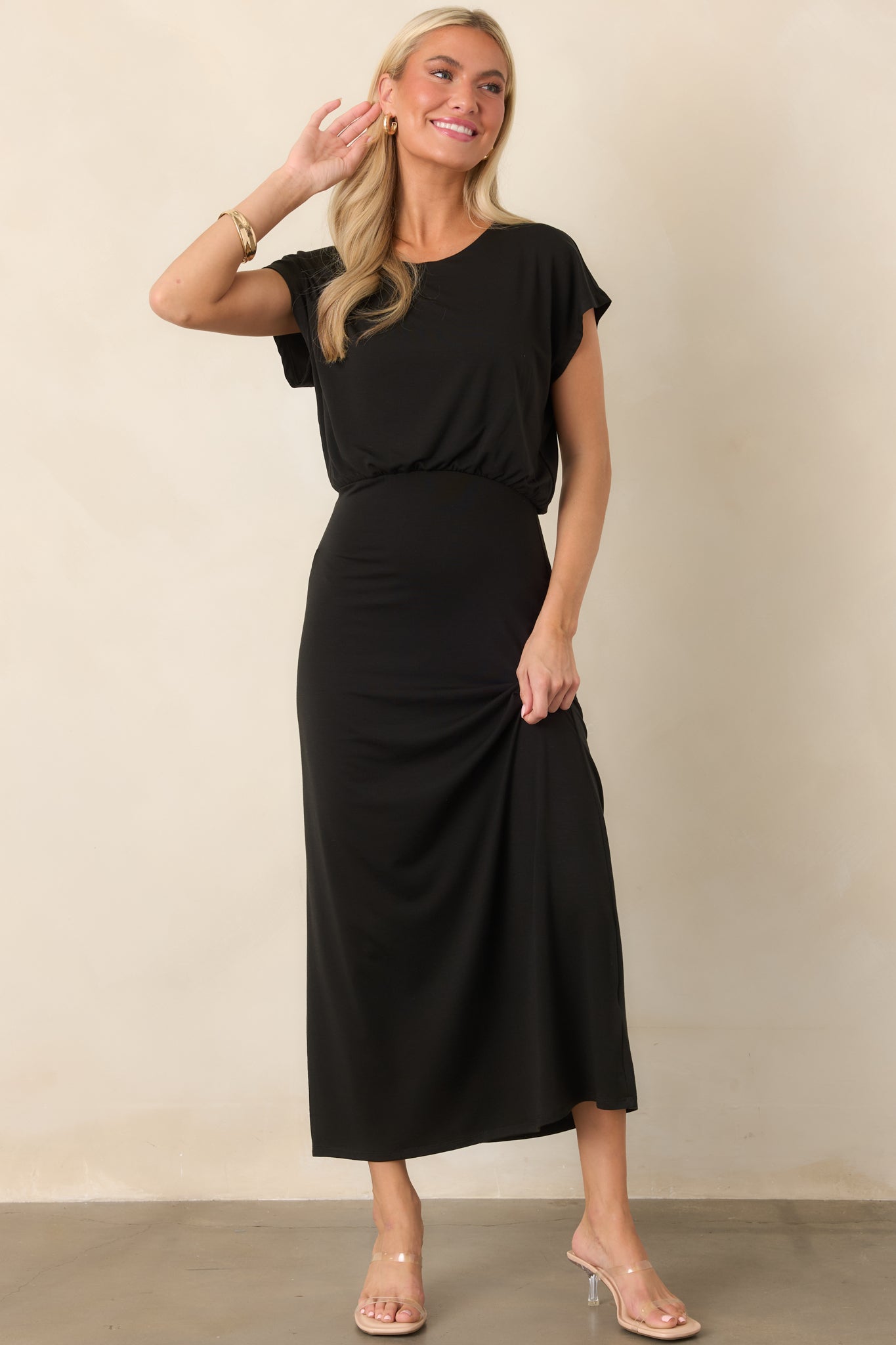 Soft stretch jersey midi silhouette showcasing a classic crew neckline, gently draped bodice, and sleek flowing skirt.