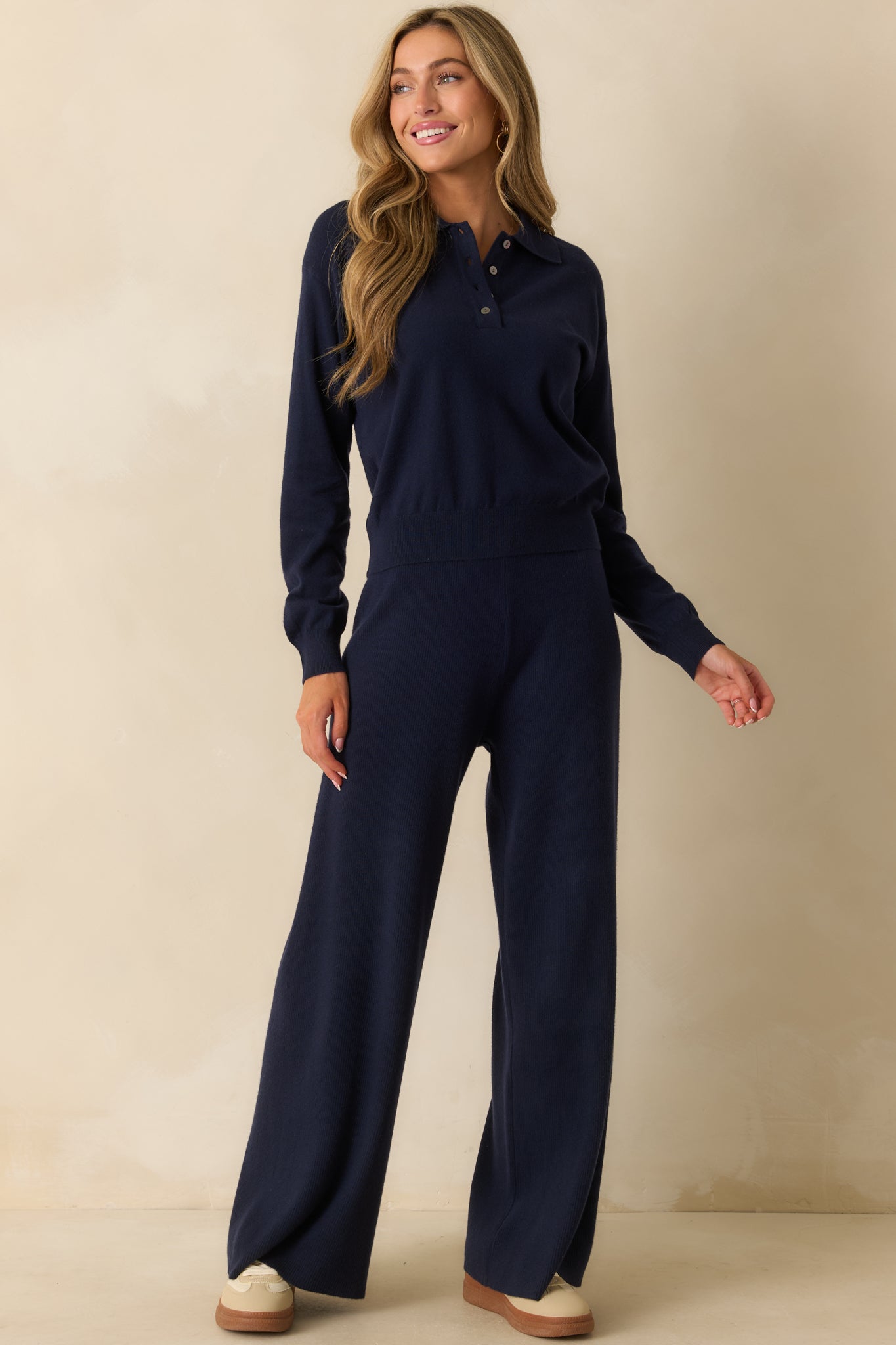 Soft stretch navy pants showing the flowy wide-leg design and smooth knit texture.