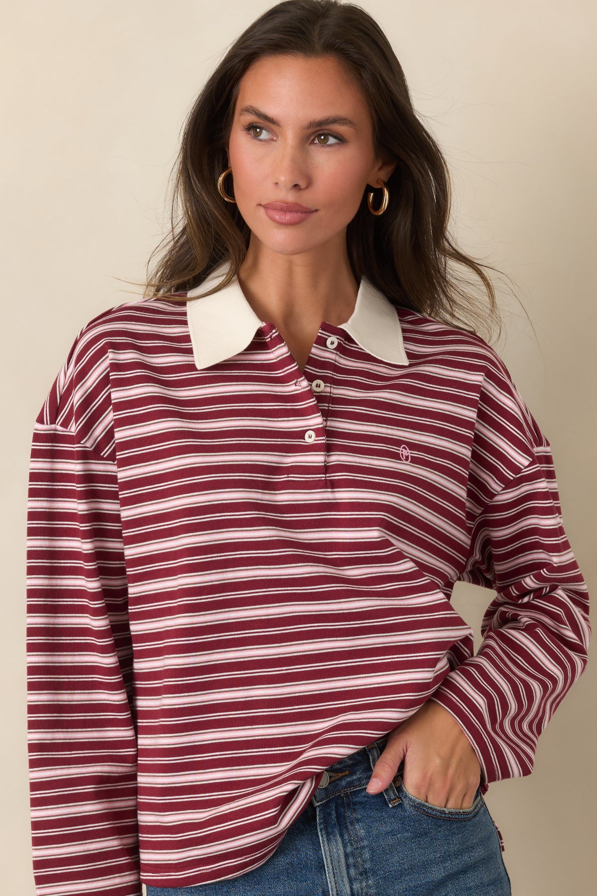 Soft striped cotton top featuring a partial button placket, contrasting collar, and casually dropped shoulders.