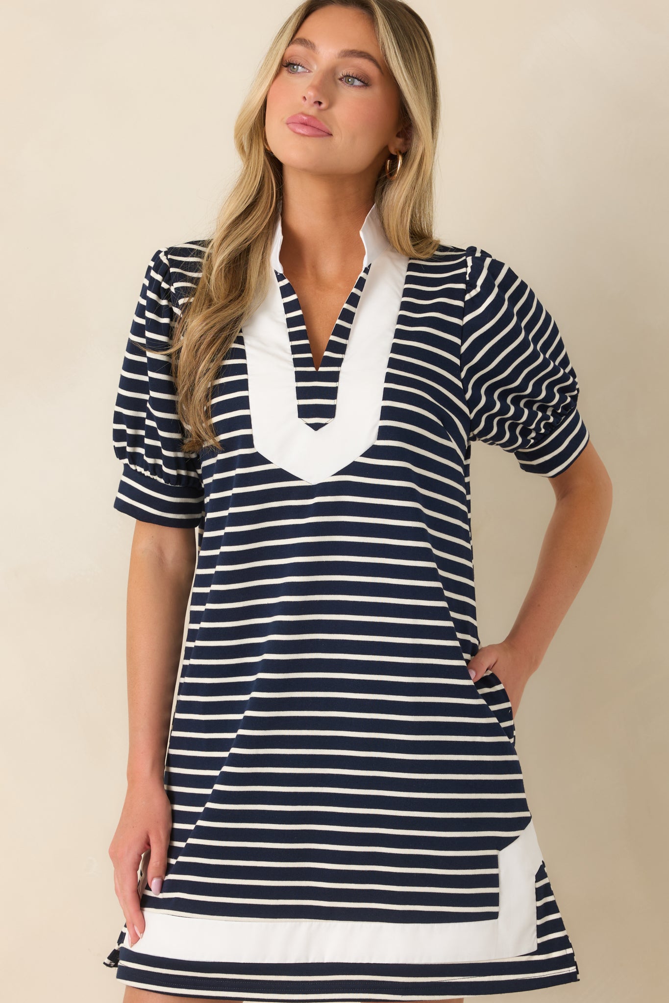 Soft striped shift dress showcasing the white-trimmed split neckline, mini-length design, and functional side pockets.