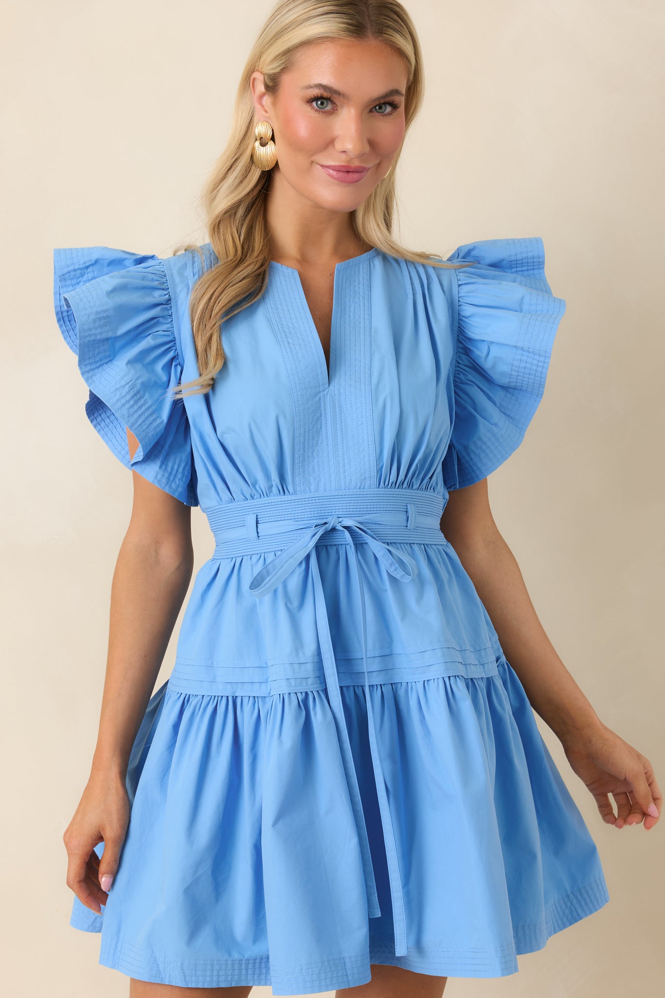Soft tiered fabric and defined waistline on feminine mini dress