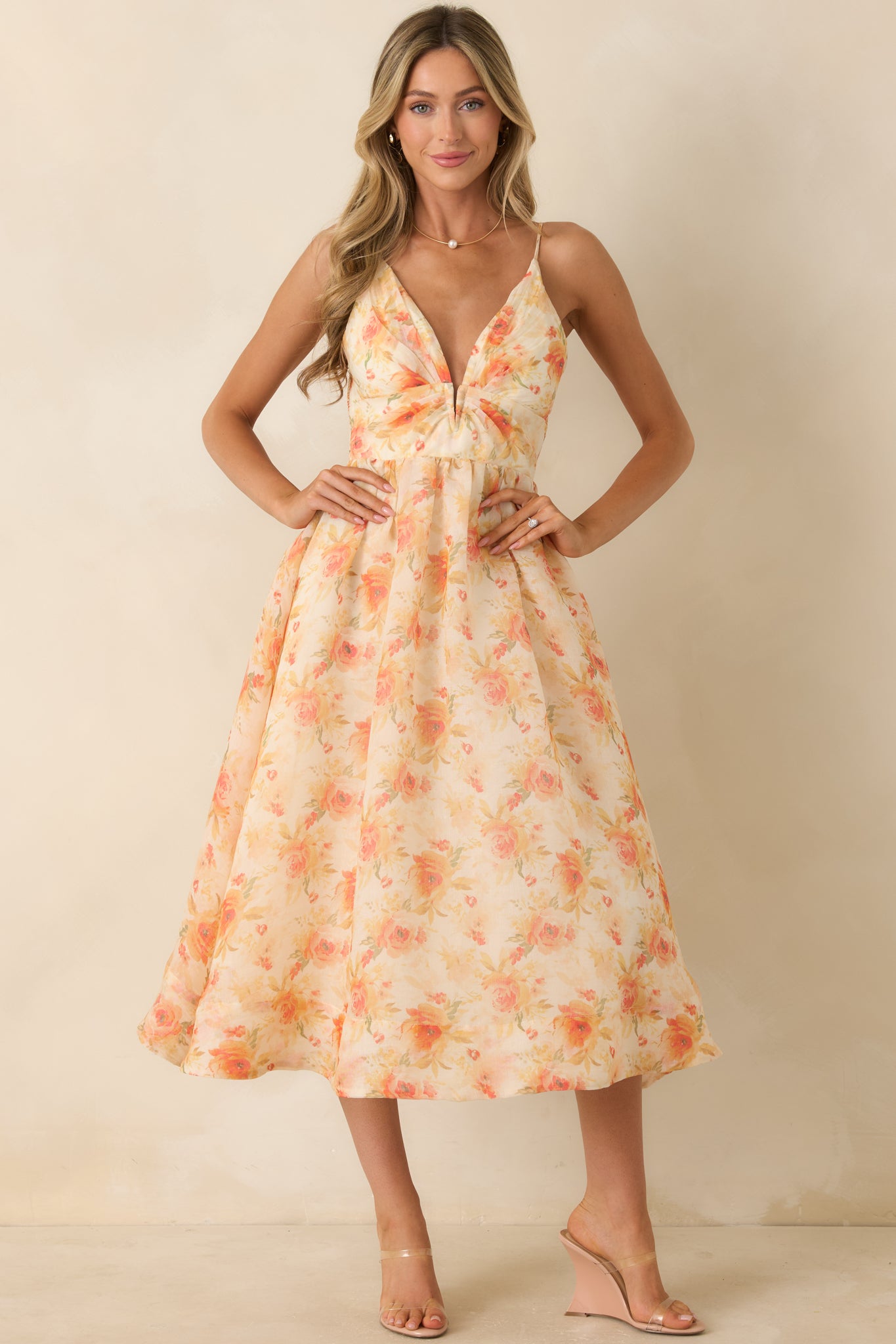 Soft watercolor floral midi dress showcasing gathered bust detailing and a lightweight, airy silhouette.