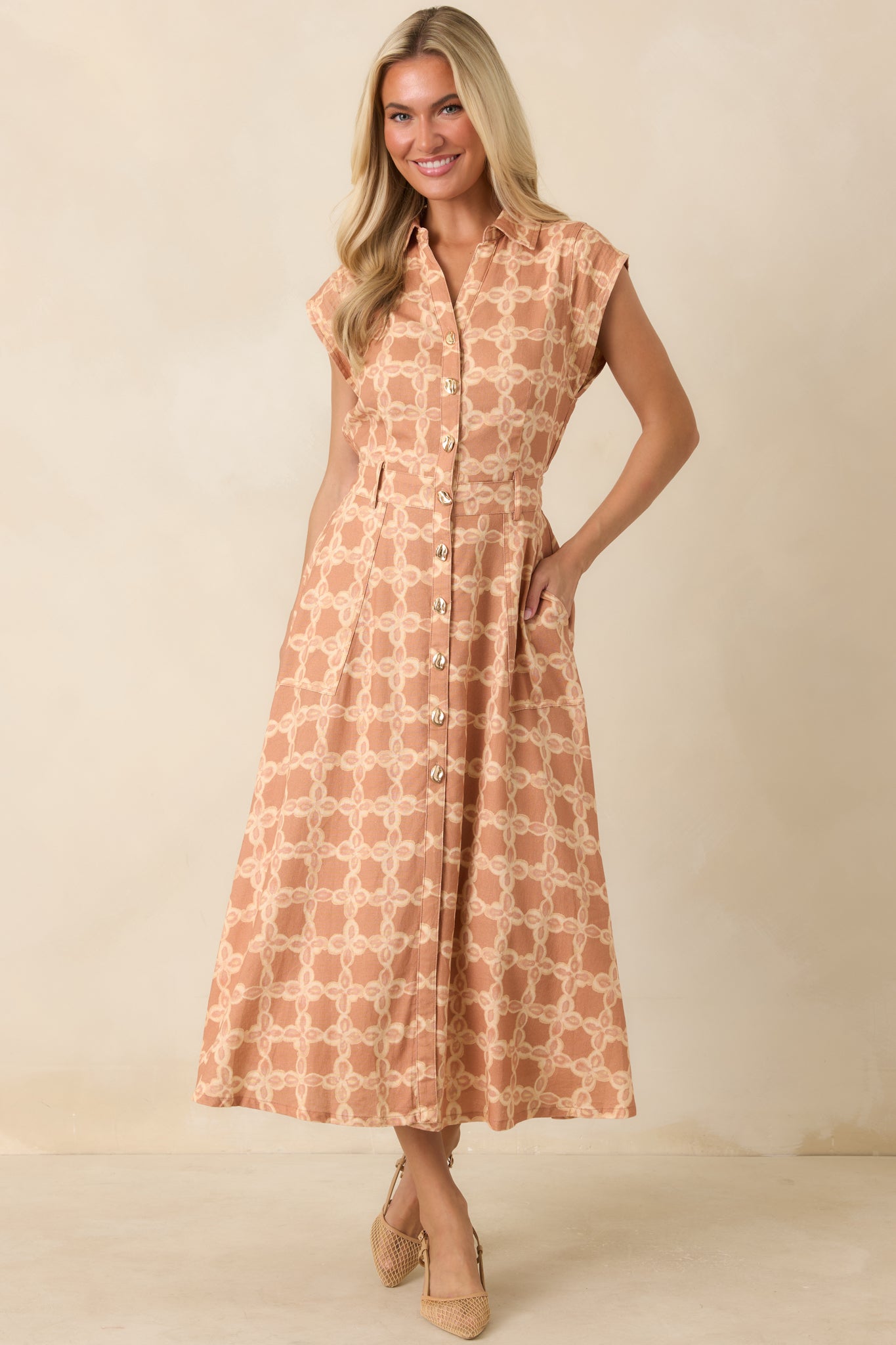 Soft woven midi dress featuring a classic collared neckline, functional button front, and an easy flowing silhouette.