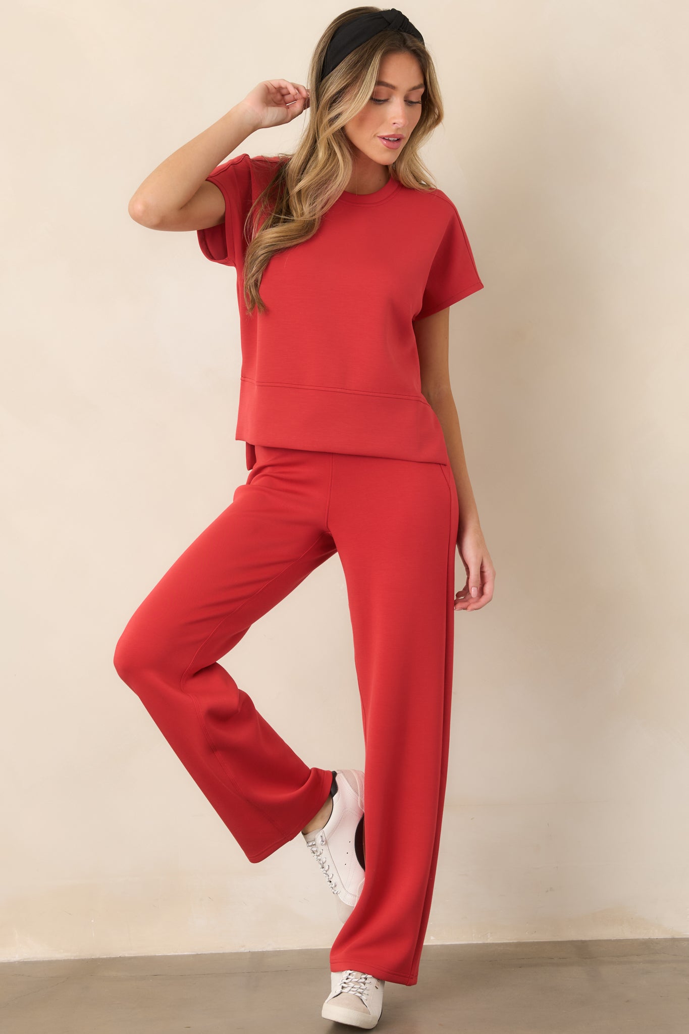 Softly draped top with a crew neckline, short sleeves, and an elevated high-low silhouette designed for added coverage.