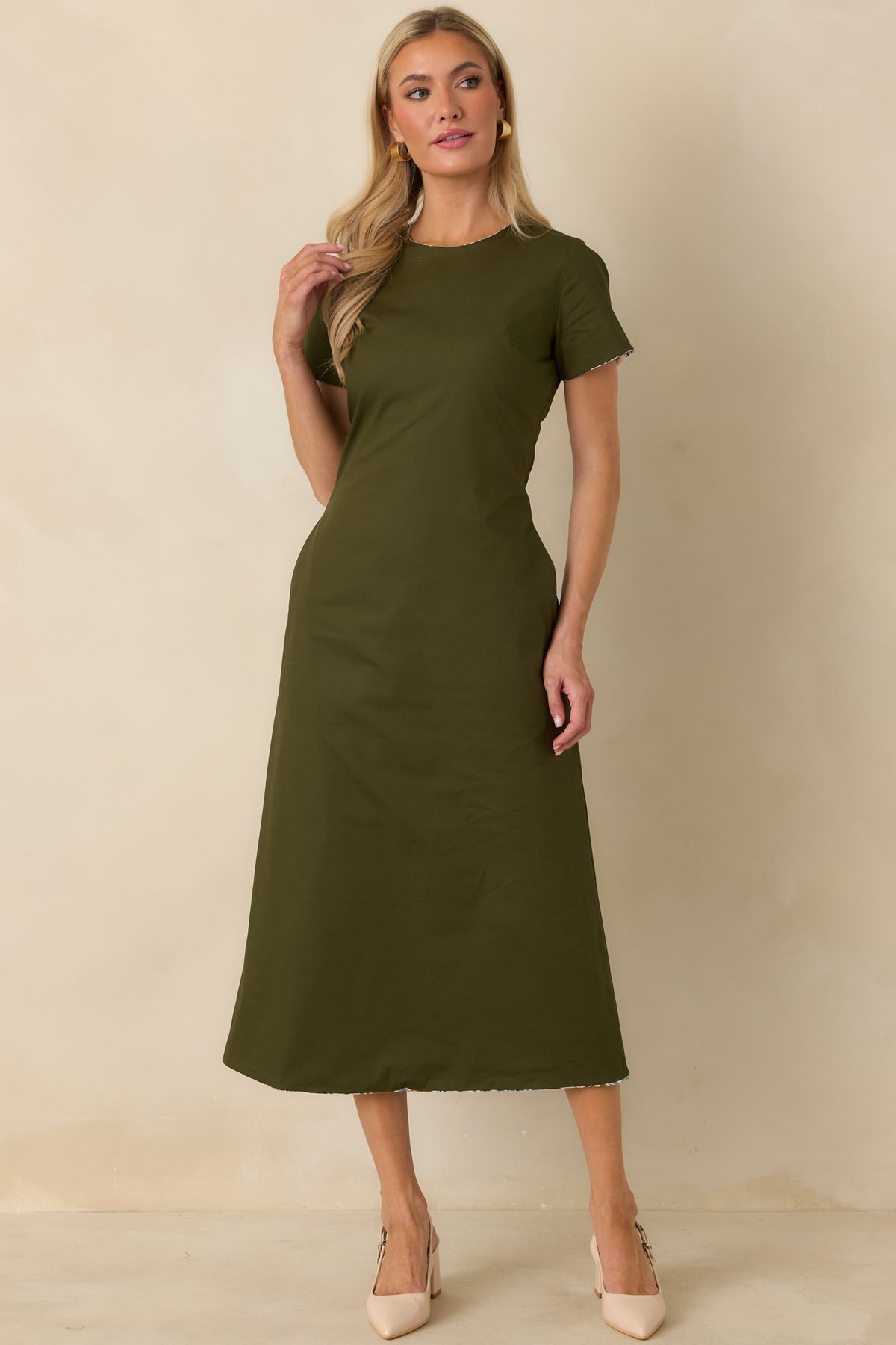 Solid olive reversible dress with a softly tailored silhouette and classic round neckline designed for polished wear.