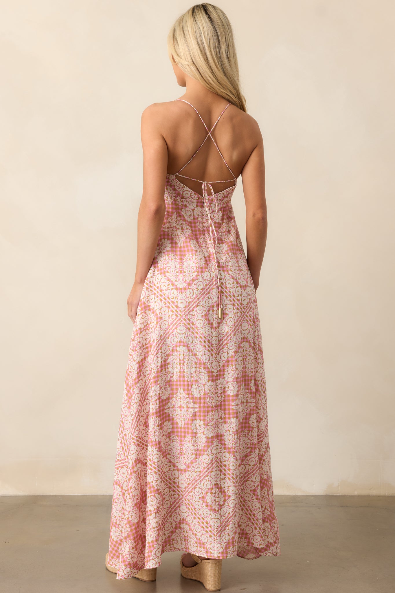 Spaghetti straps with crossed back self-tie detailing create a unique and adjustable finish at the back.