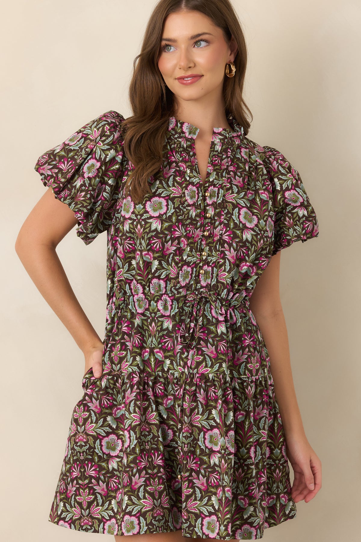 Split neckline framed by flutter sleeves and accented with pleated front detailing and polished gold-tone buttons.