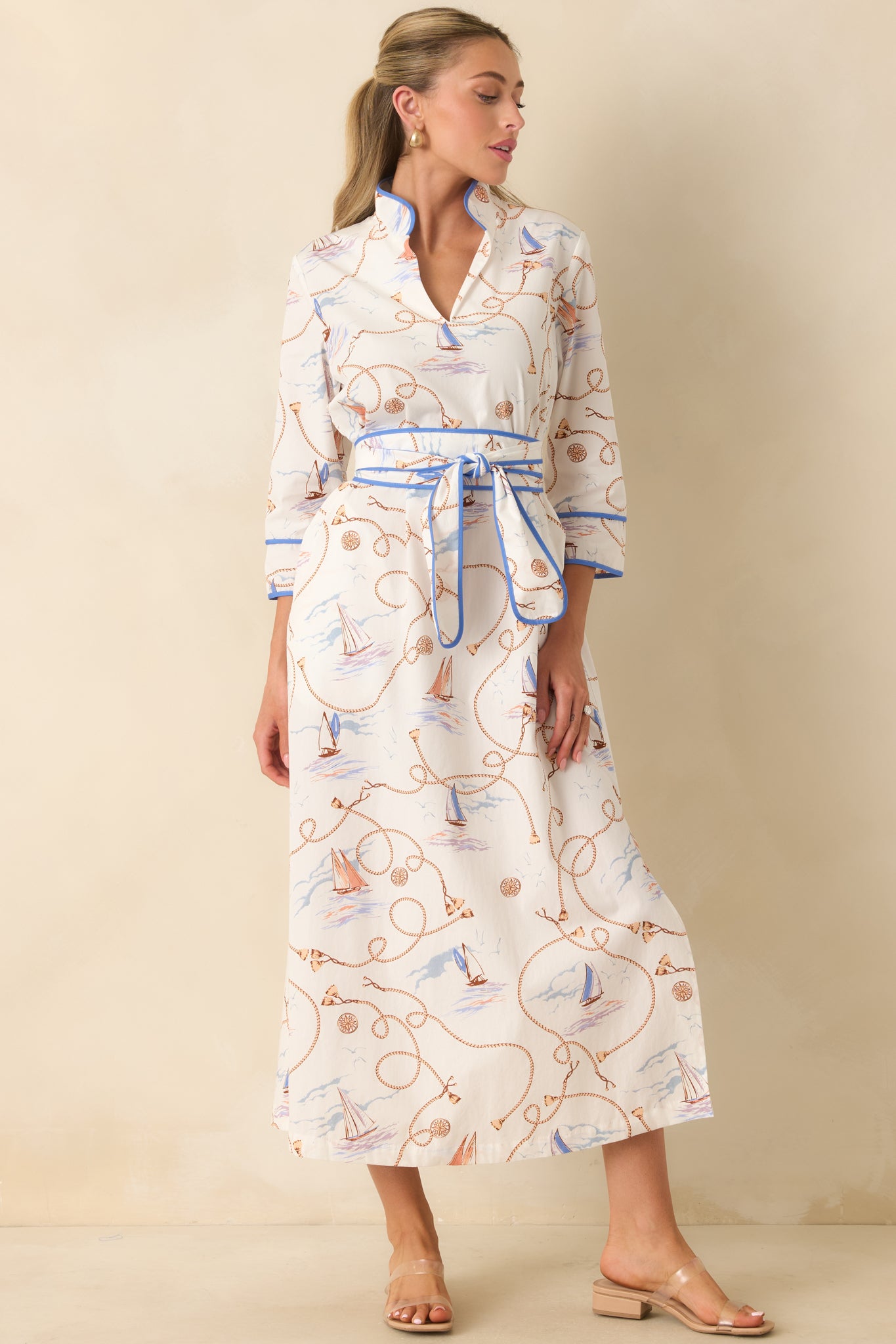 Cotton maxi dress showcasing a split neckline, three-quarter sleeves, coordinating sash belt, and flowing skirt with side slit.