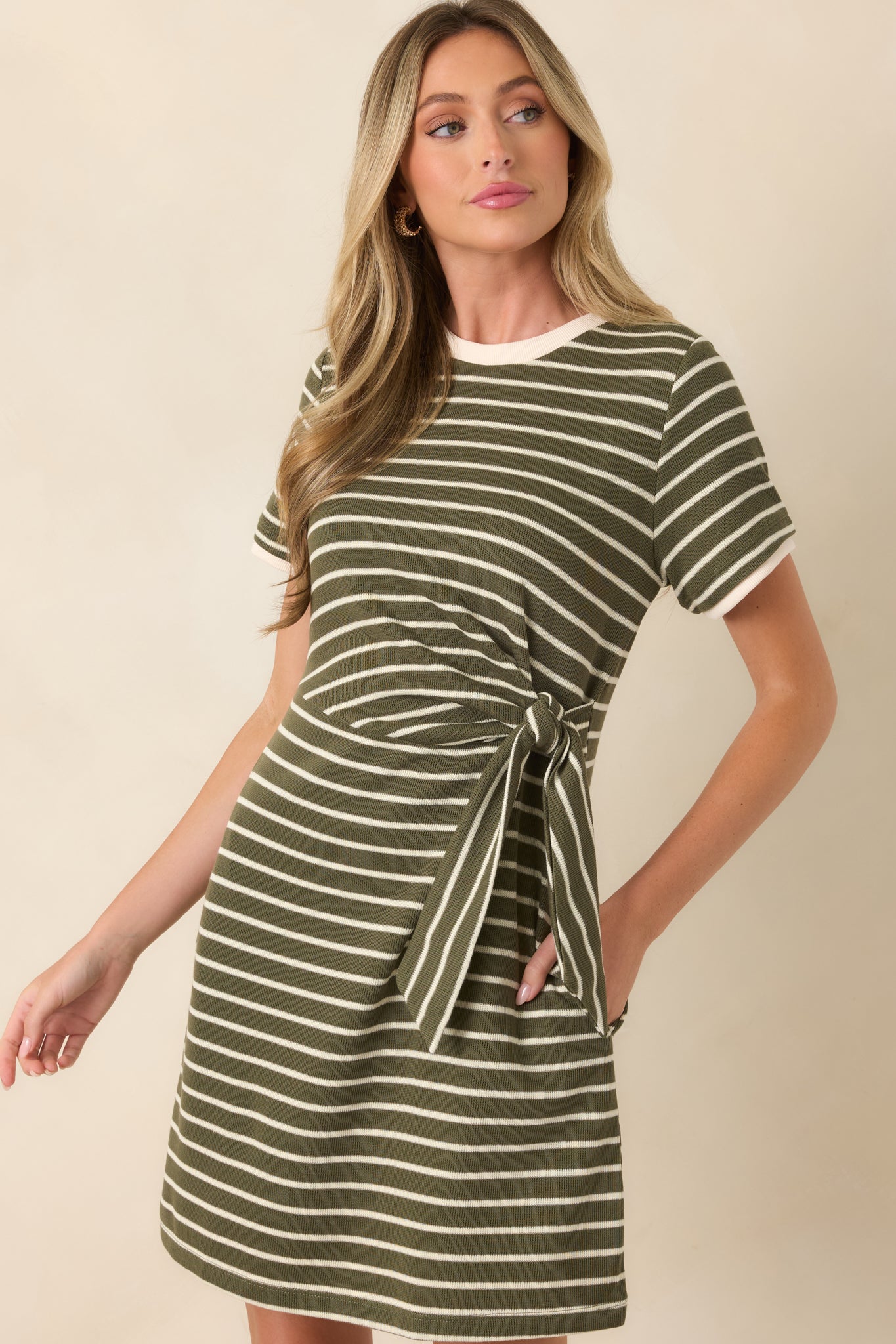 Detailed view of the striped mini dress highlighting the adjustable side tie and classic horizontal stripe pattern throughout