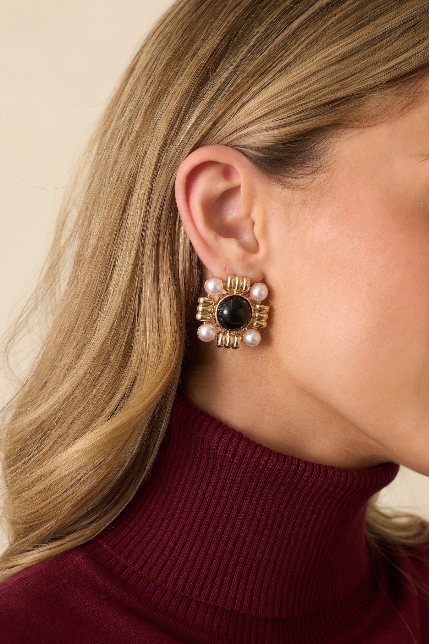 Square black stone earrings accented with four ivory faux pearls and textured gold details.
