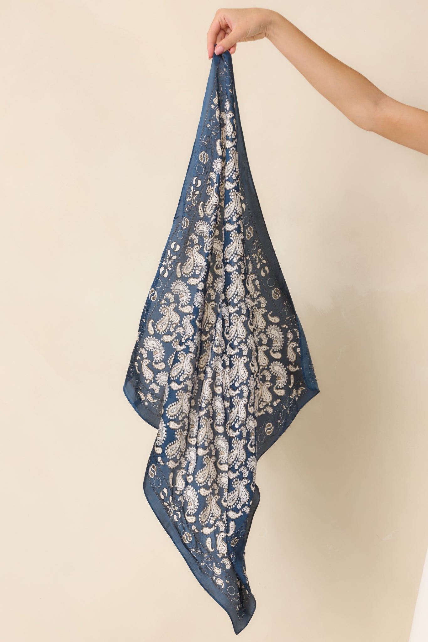 Navy and ivory square hair scarf displayed to showcase the intricate paisley pattern and neatly framed coordinating border.