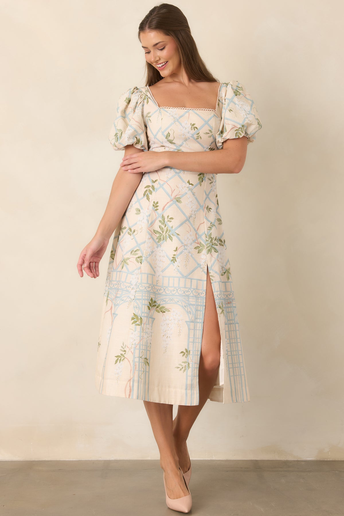 Square-neck dress with defined waist and flowing midi skirt