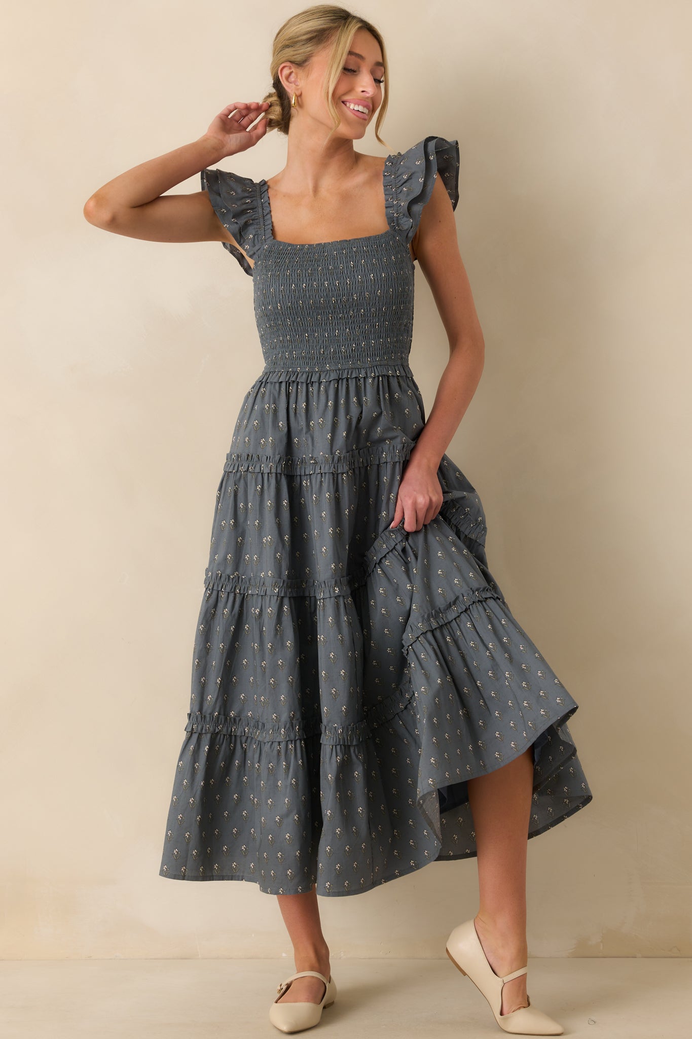 Square-neck midi dress with smocked detailing and flutter sleeve accents.