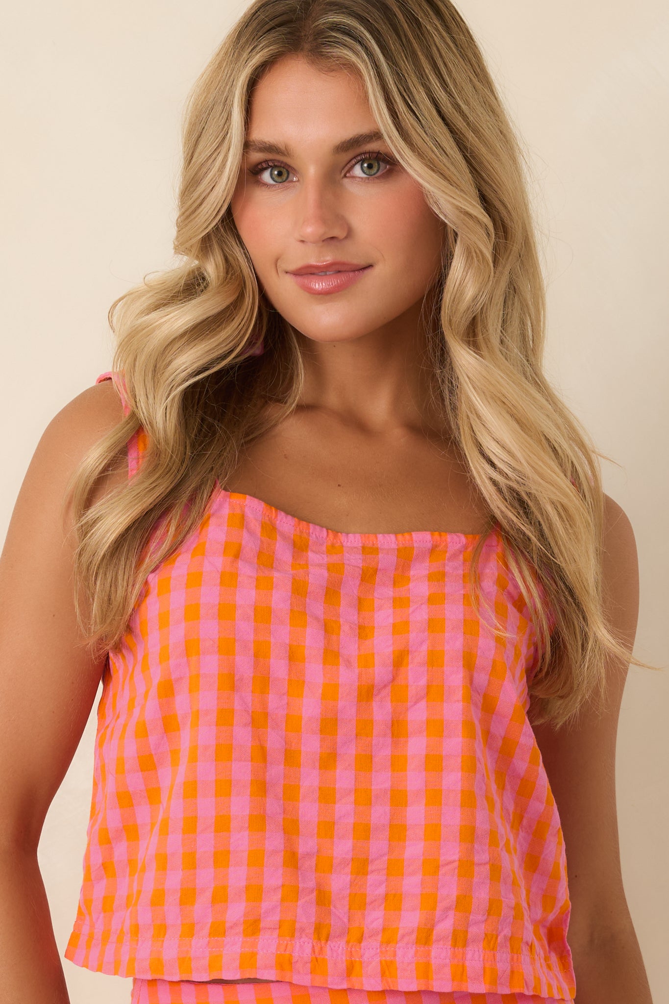 Square neckline adds a clean, flattering finish to this pink and orange plaid cropped cotton tank.