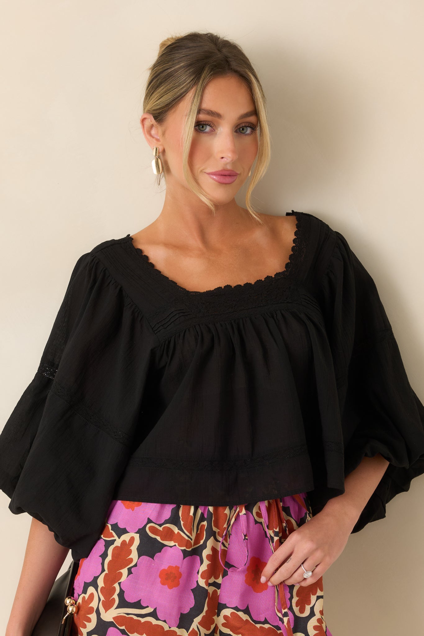 Close view highlighting the softly gathered square neckline with delicate scalloped trim and lace inset detailing.
