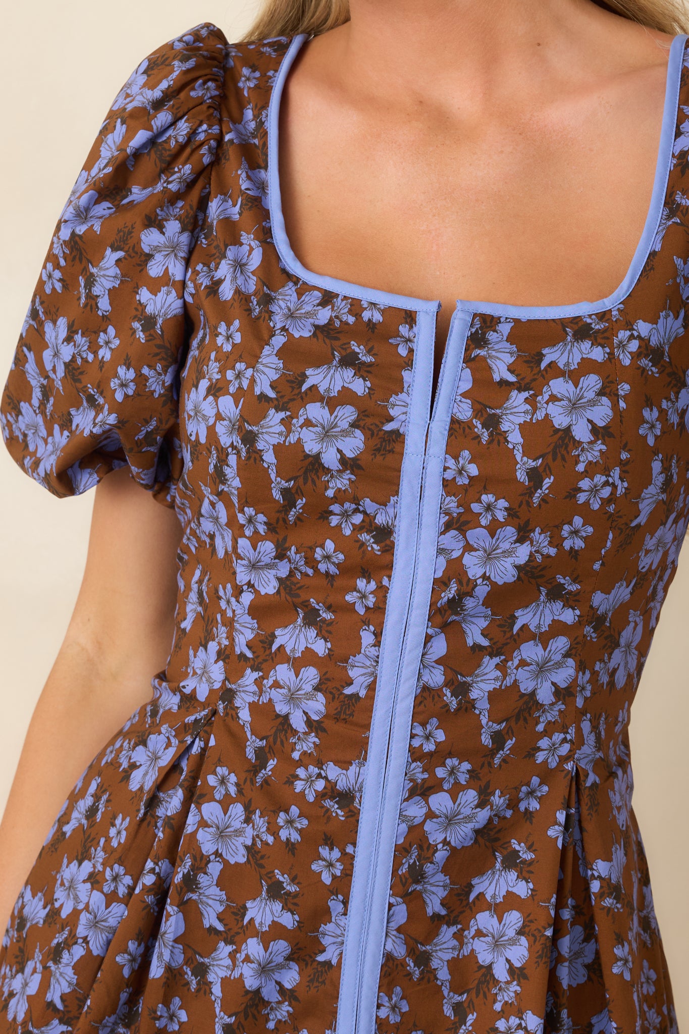 Close-up of the square neckline and coordinating blue trim, highlighting the smooth cotton fabric and contrast detailing.