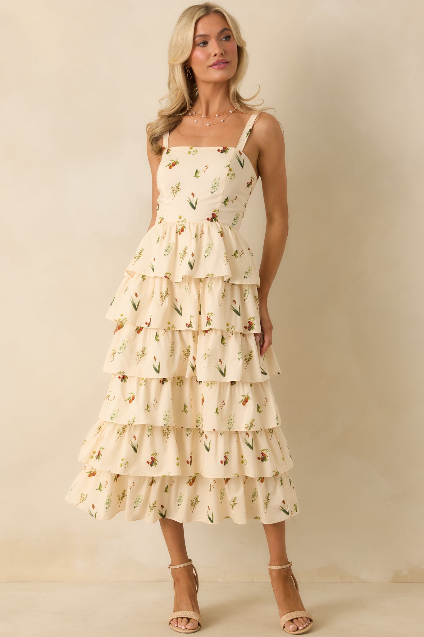 Square neckline ivory midi dress with colorful floral print and structured bodice panels.