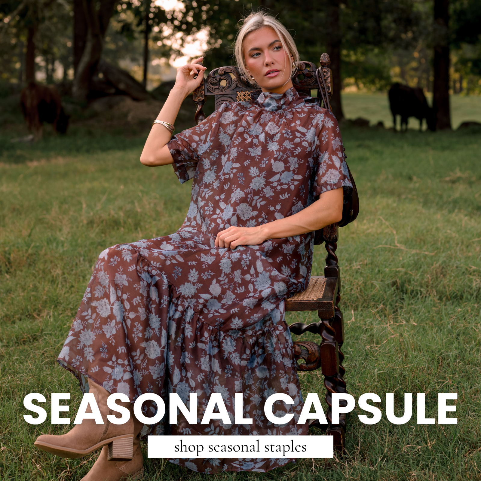 Model wearing a brown floral maxi dress and tan ankle boots, seated outdoors in a grassy setting. Text reads “Seasonal Capsule” and “Shop Seasonal Staples.”