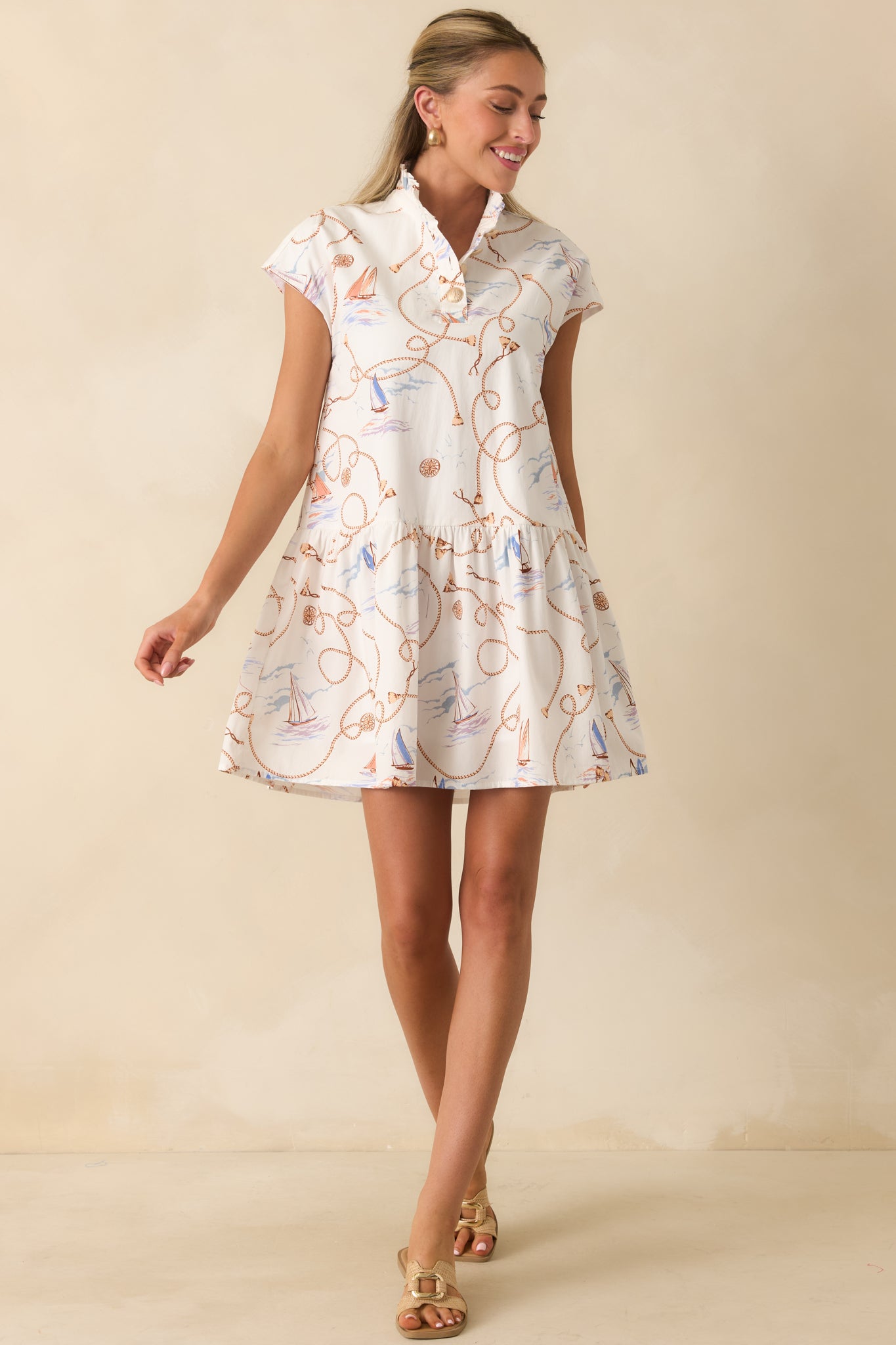 Mini dress designed with a stand collar, cap sleeves, and a playful flouncy skirt for effortless movement.