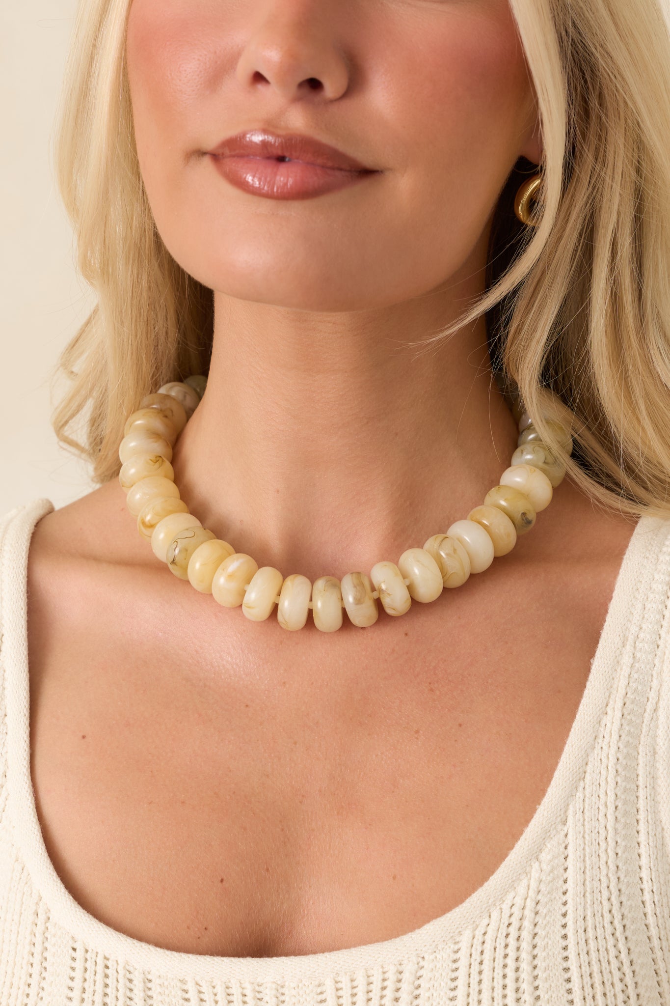 Statement necklace with a smooth curved design adding subtle texture and a polished finish.