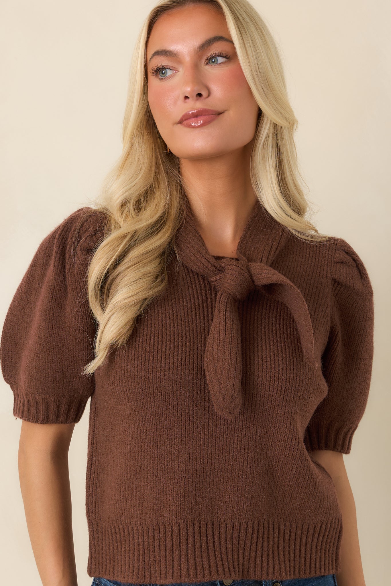 Front detail of the fitted knit top highlighting the statement neckline and clean ribbed hem.