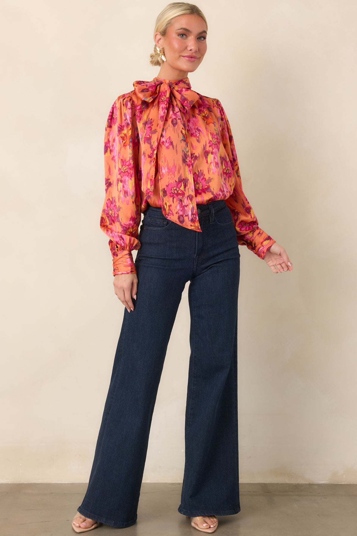 Statement polyester satin top featuring a fluid drape, lightly gathered shoulders, dramatic neck tie, and full balloon sleeves for added volume.