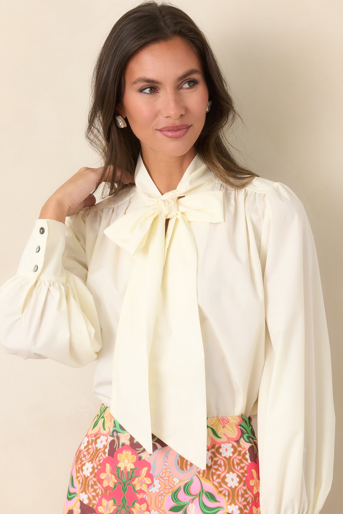 Statement tie neckline creates a polished focal point on the smooth blend blouse.
