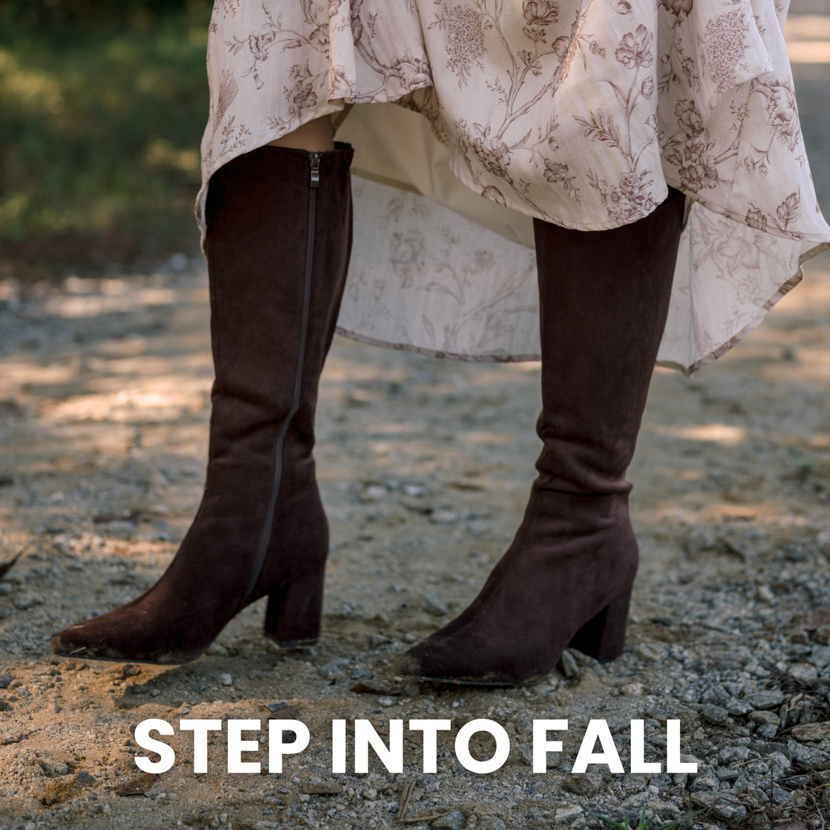 Model wearing a floral skirt with brown suede boots.