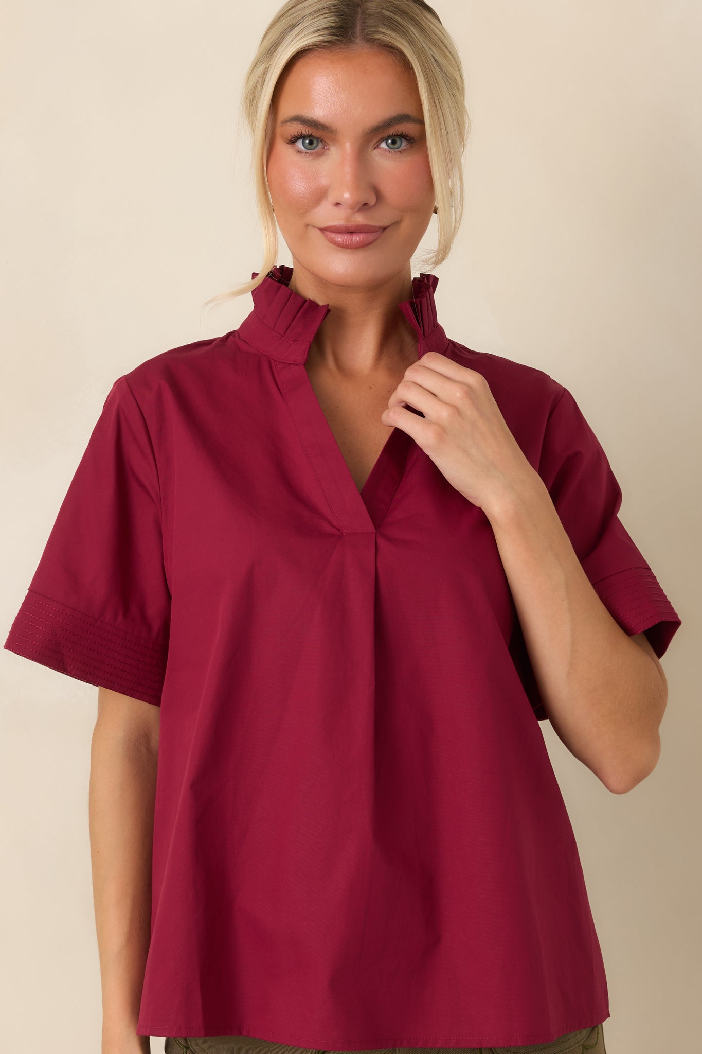 Detailed view highlighting the stitched short sleeve cuffs and breathable cotton texture of the blouse.