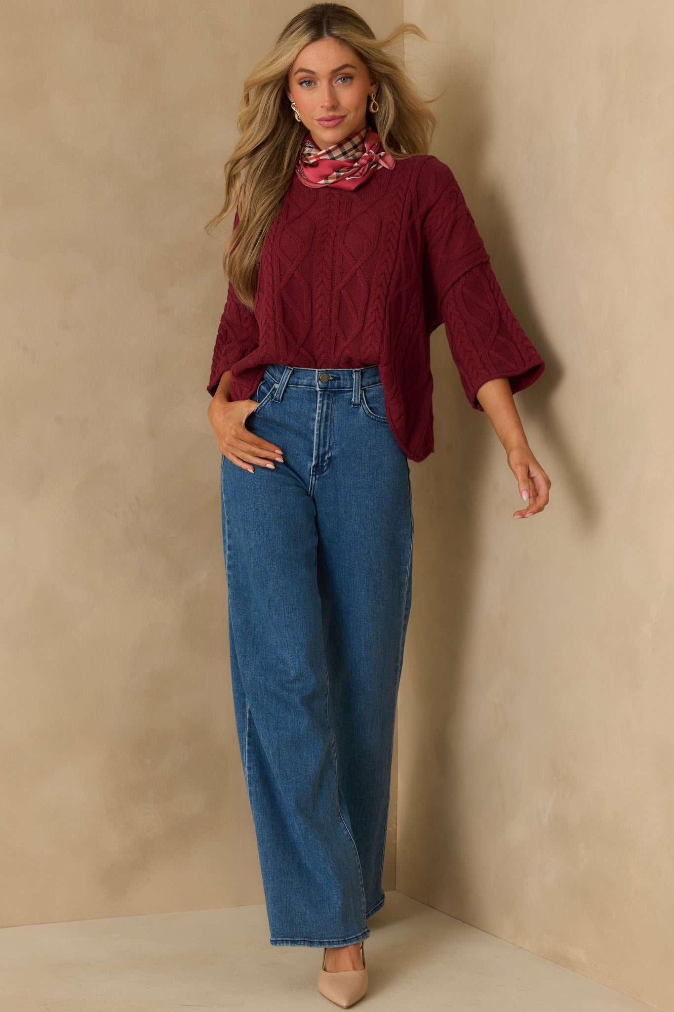 Straight-on image of the sweater emphasizing its cropped 3/4 sleeves and ribbed neckline.