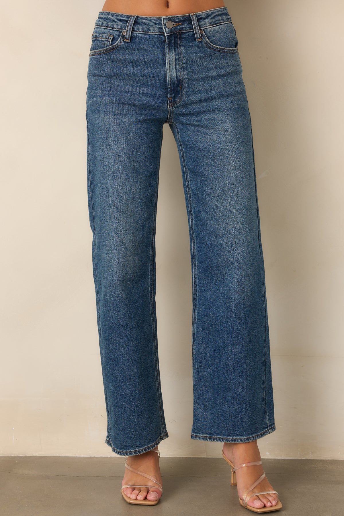 Straight leg denim with a high-rise waist and lived-in medium wash.
