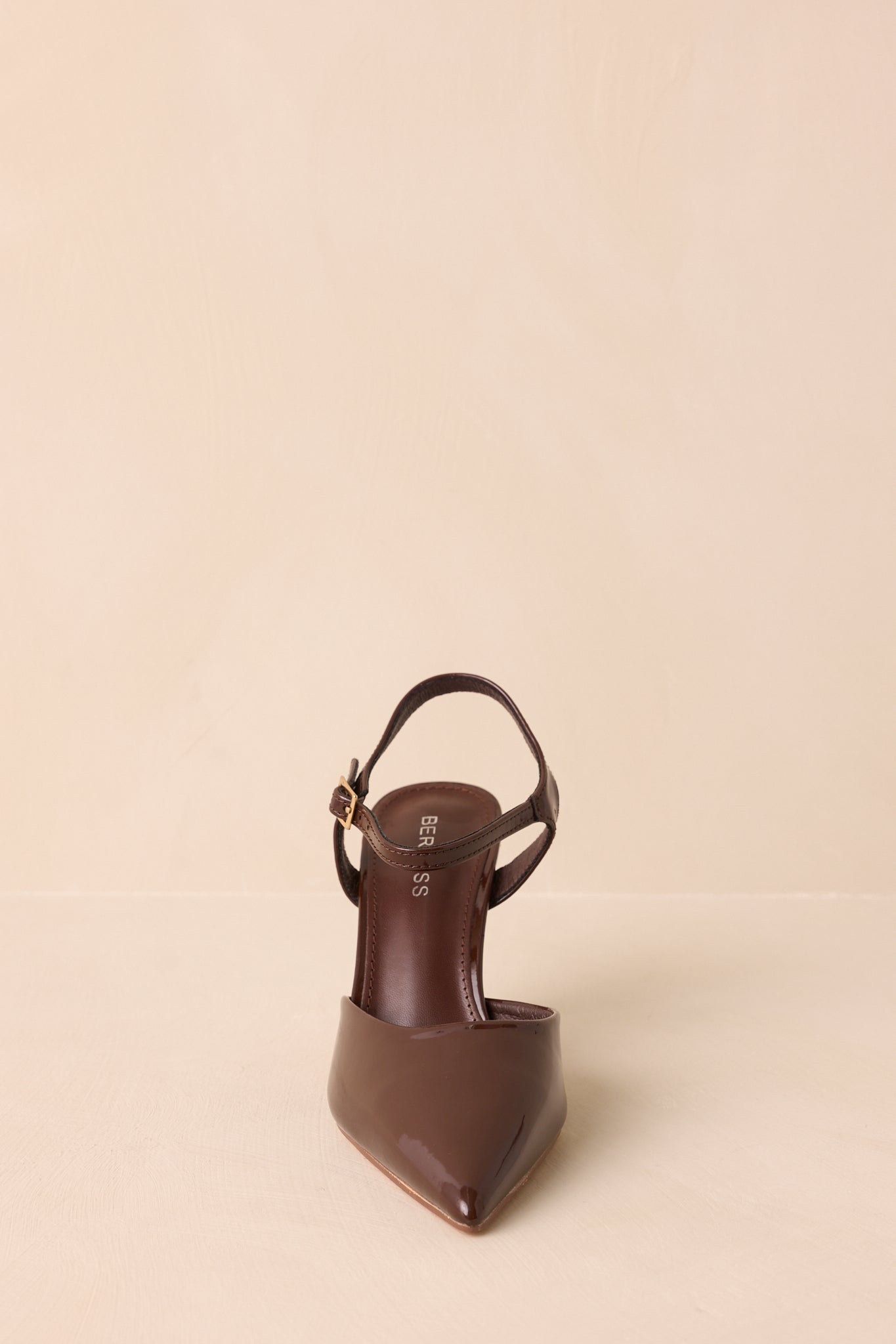 A straight-on front angle showing the footbed, ankle strap placement, and pointed shape.