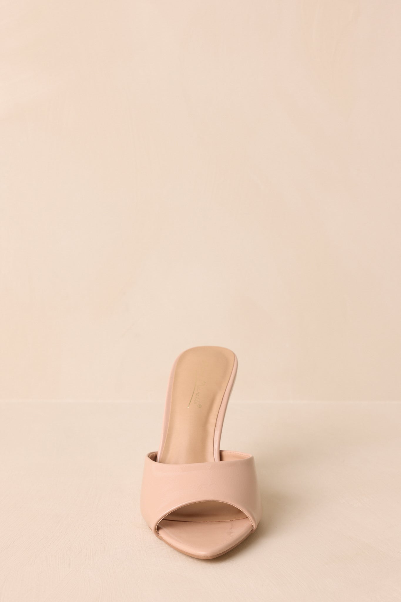 A straight-on shot focusing on the open-toe silhouette and faux leather strap.