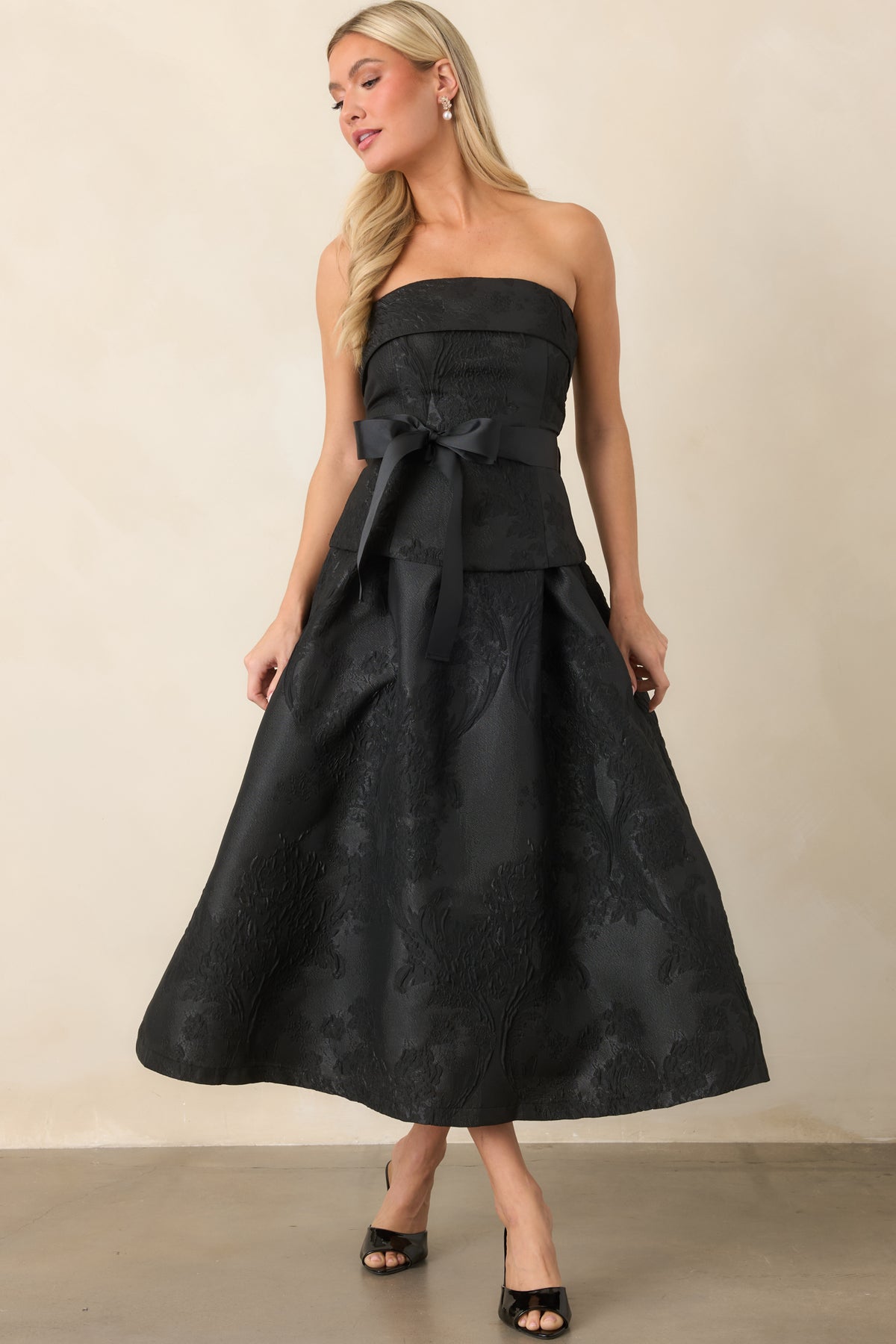 Strapless A-line midi dress featuring a sculpted bodice, split peplum overlay, and wide waist sash.