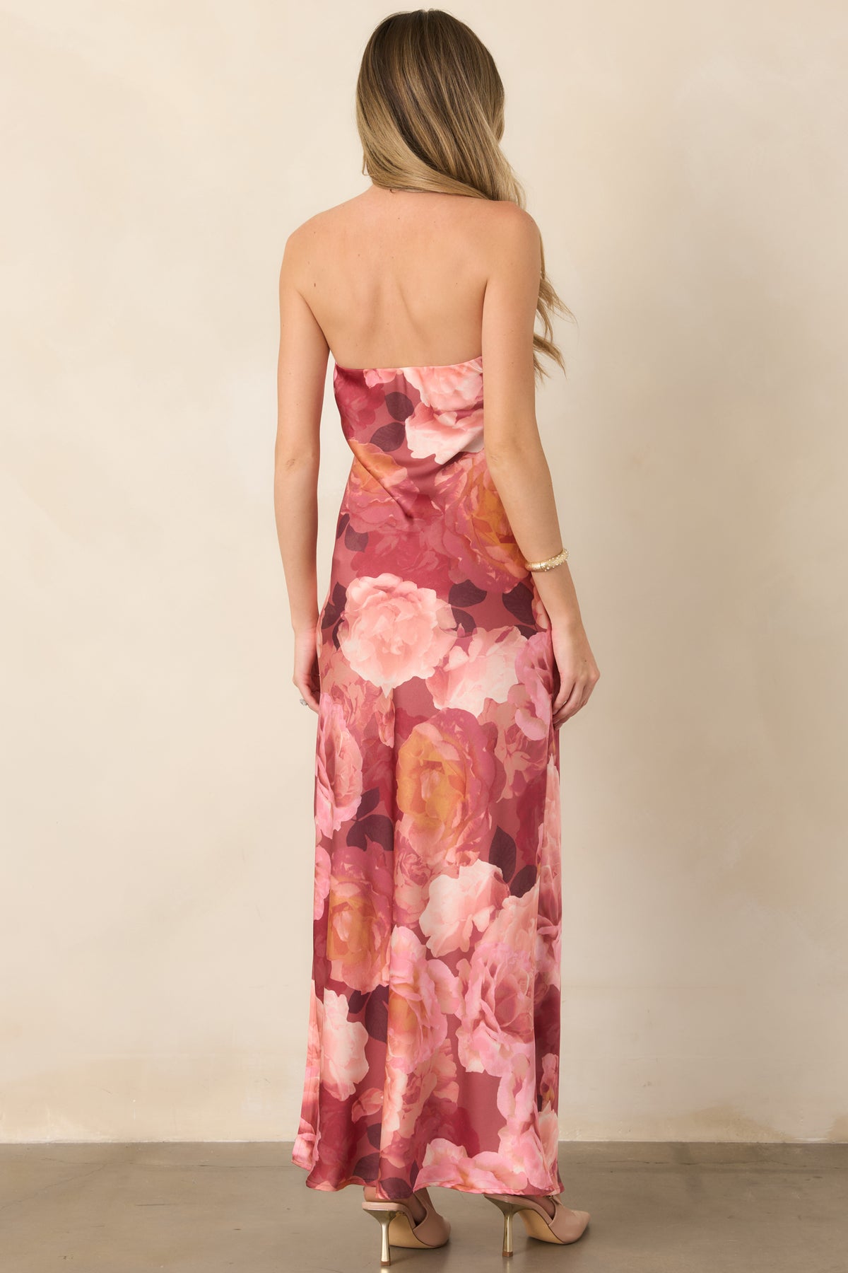 Rear view of the strapless floral maxi dress, showcasing its figure-skimming silhouette, full-length hem, and oversized multicolored blooms.