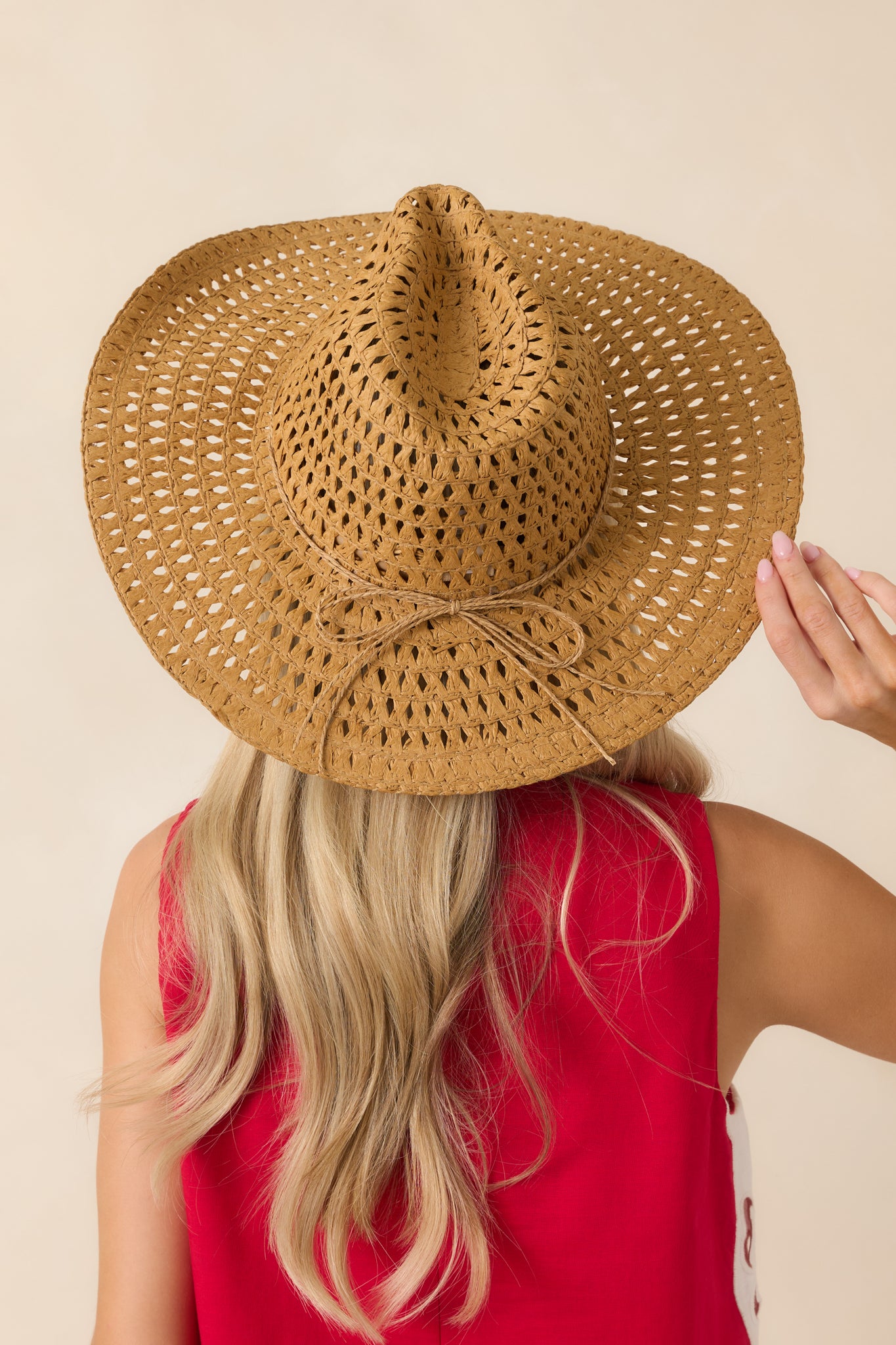 Back view of the open-weave straw cowboy hat showcasing the structured crown and wide brim.
