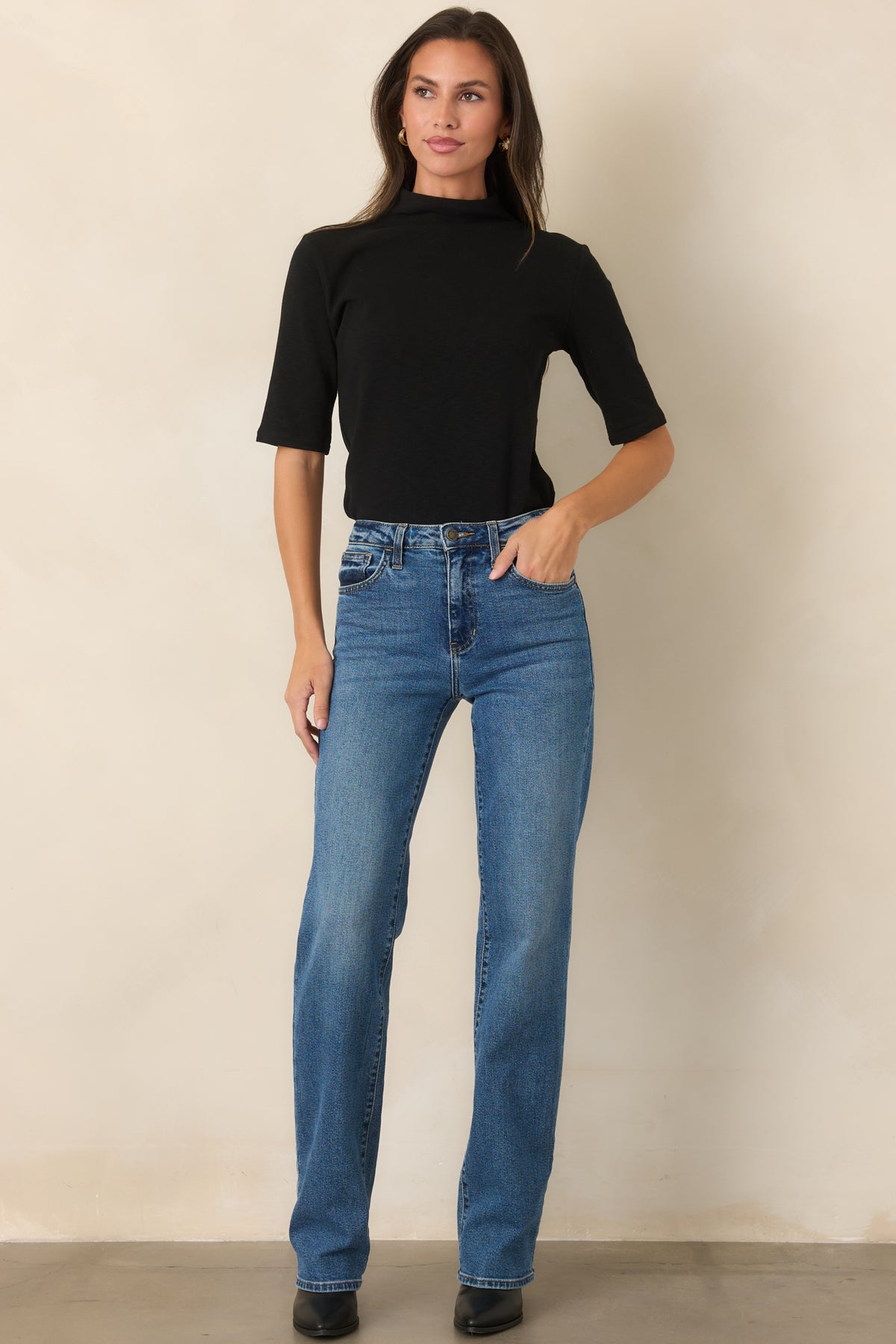 Streamlined short-sleeve knit top featuring a softly structured high turtleneck neckline and simple silhouette.