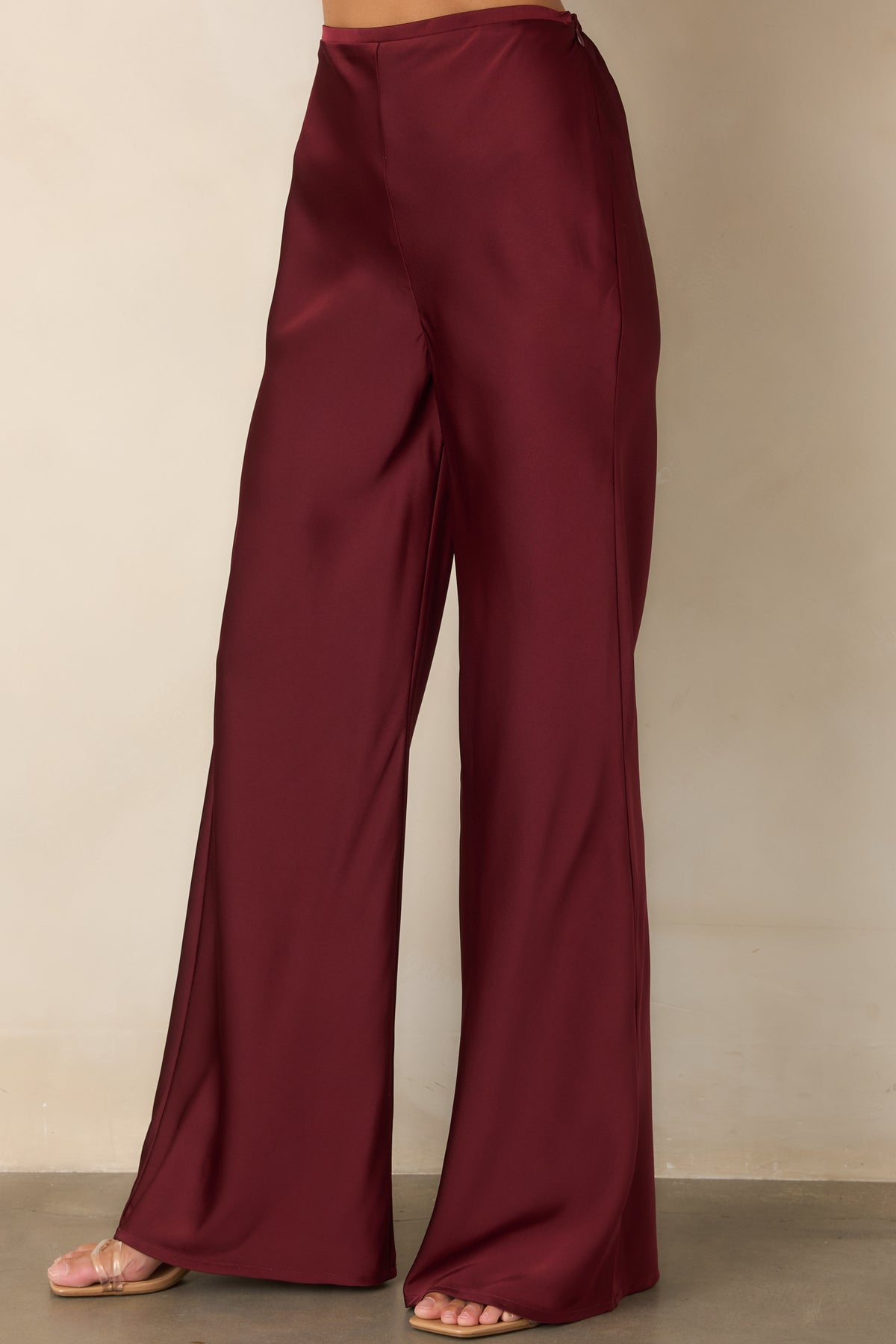Wide-leg pants emphasizing the streamlined waistband and generous, fluid leg silhouette.