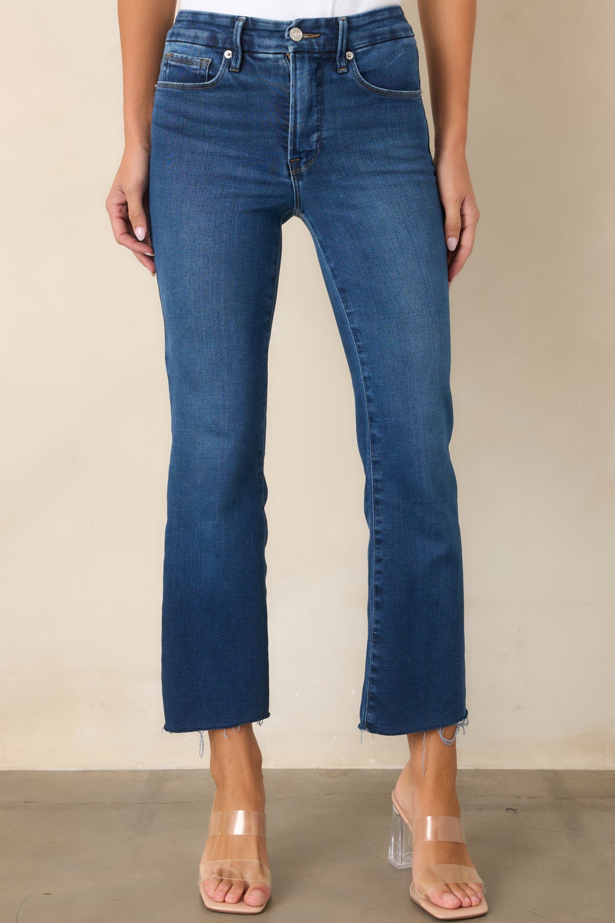  Stretch denim jeans highlighting the fitted thighs and subtle bootcut leg shape.