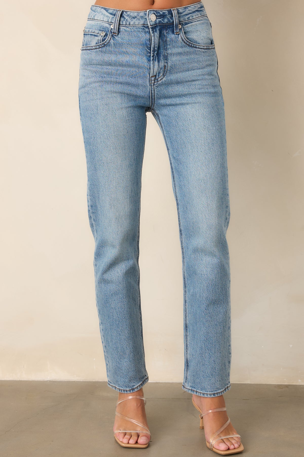 Stretch denim jeans showcasing the smooth waistline and clean straight-leg shape.

